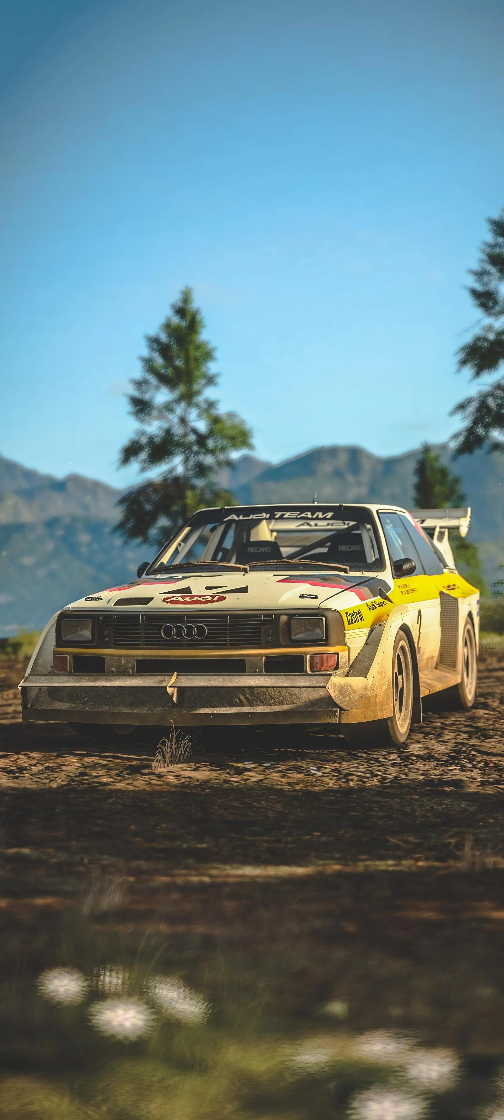 Retro Car in Forest Clearing Under Bright Blue Sky image