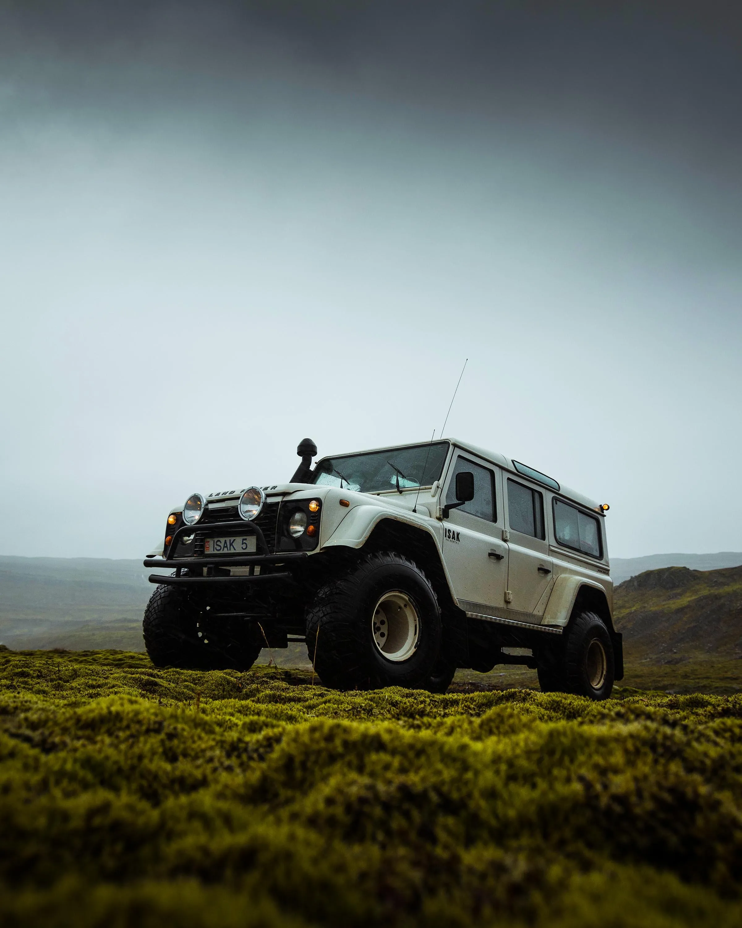 Rugged Offroad Vehicle in Misty Mountain Terrain Wallpaper