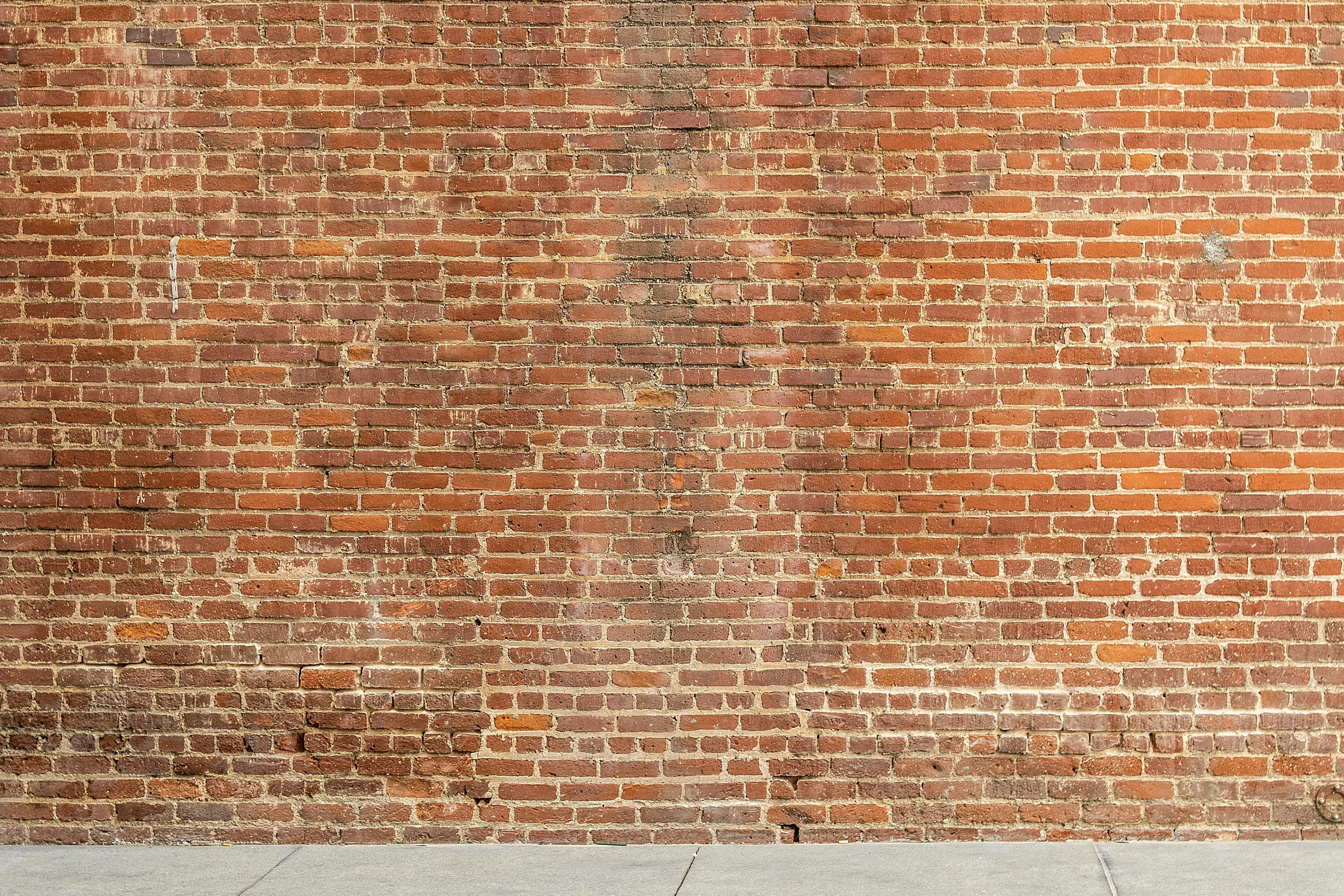 Rustic red brick wall with a weathered and Aged appearance