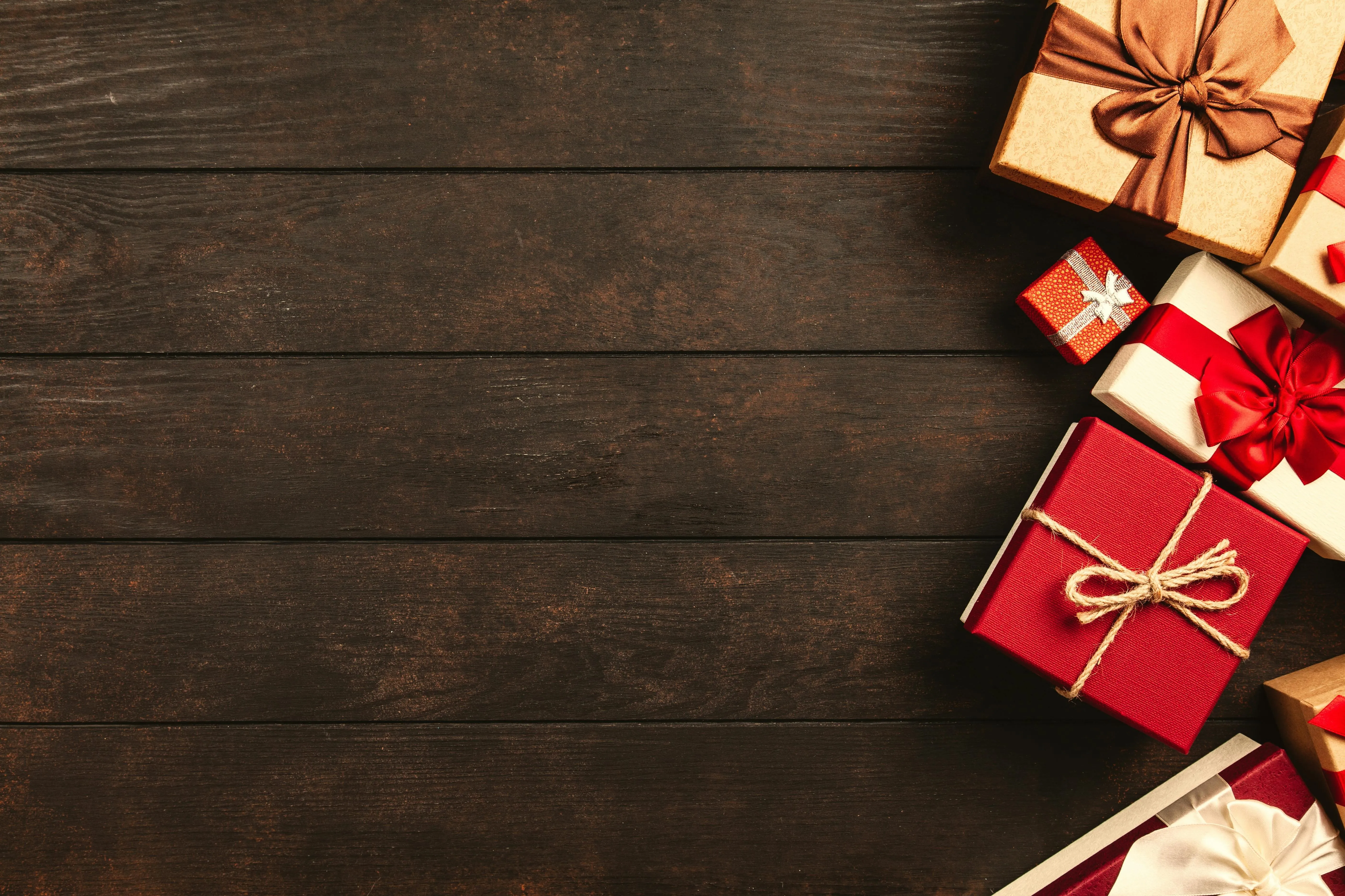 Rustic wooden surface with wrapped gift boxes in the corner