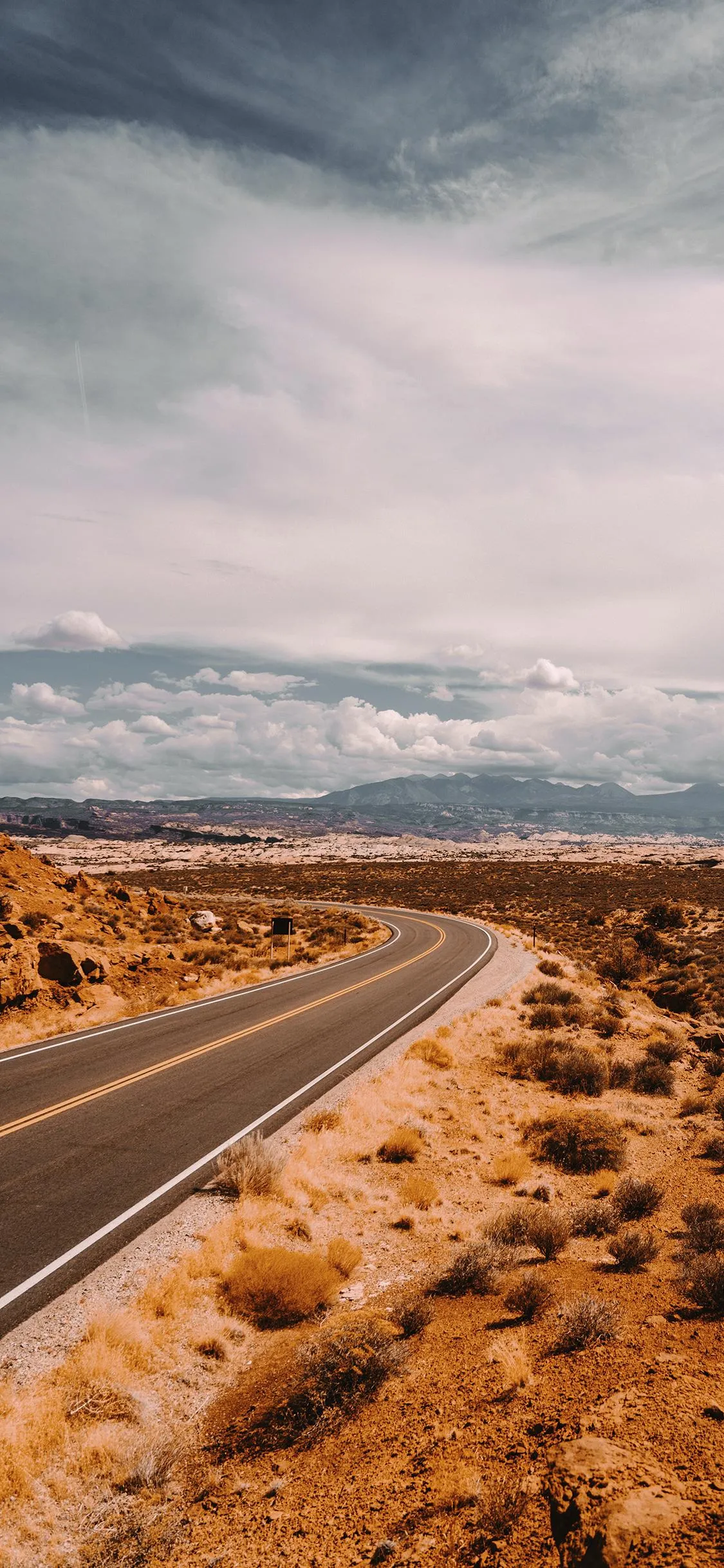 Scenic Highway through Desert under Blue Sky Wallpaper