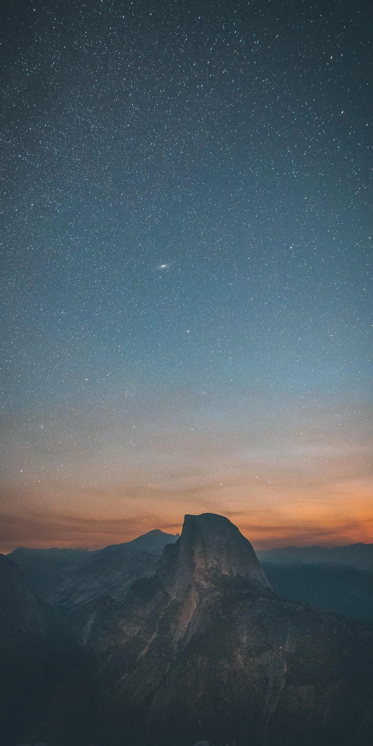 Serene mountain landscape under star filled twilight