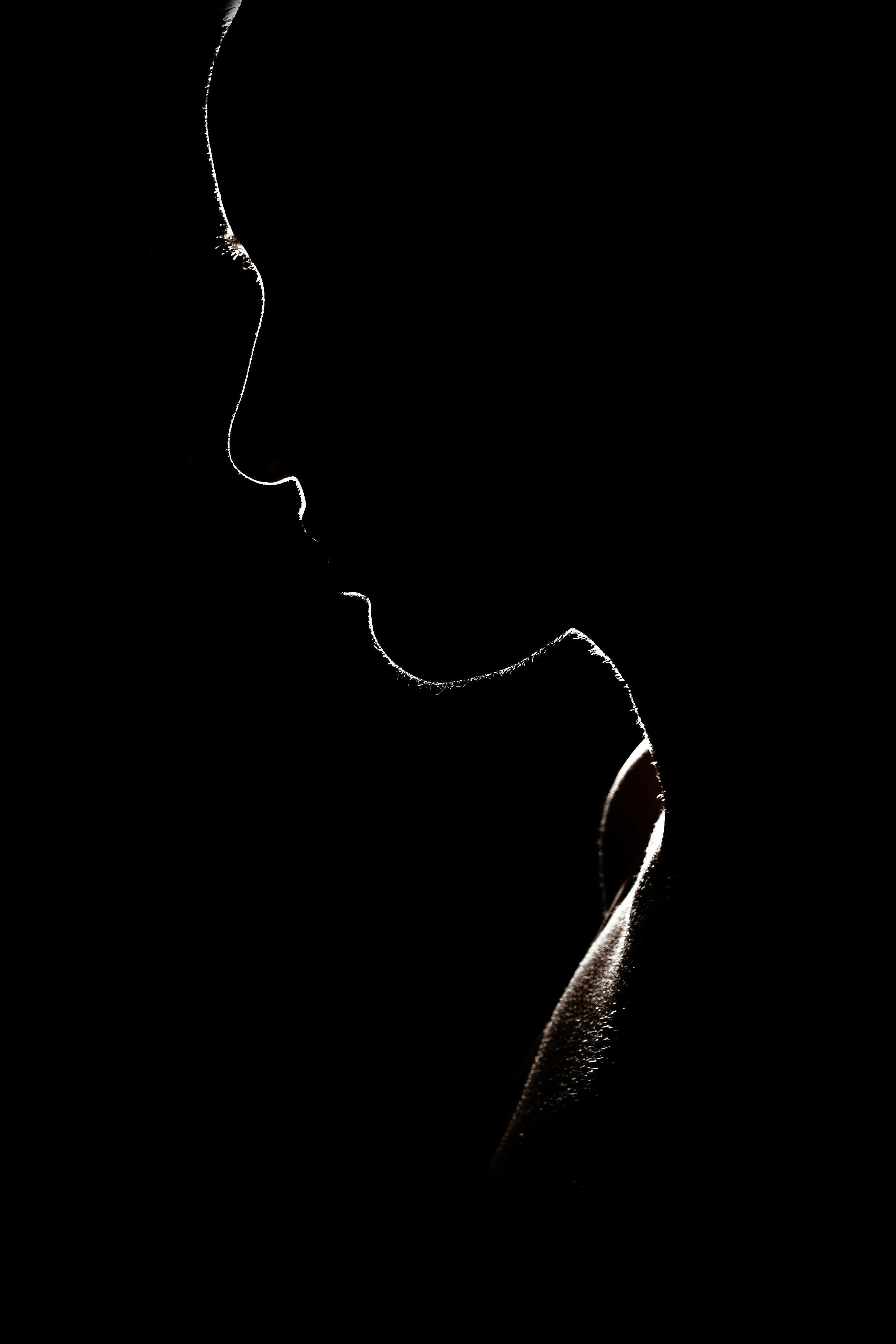 Shadow image of a person in low light on a black background