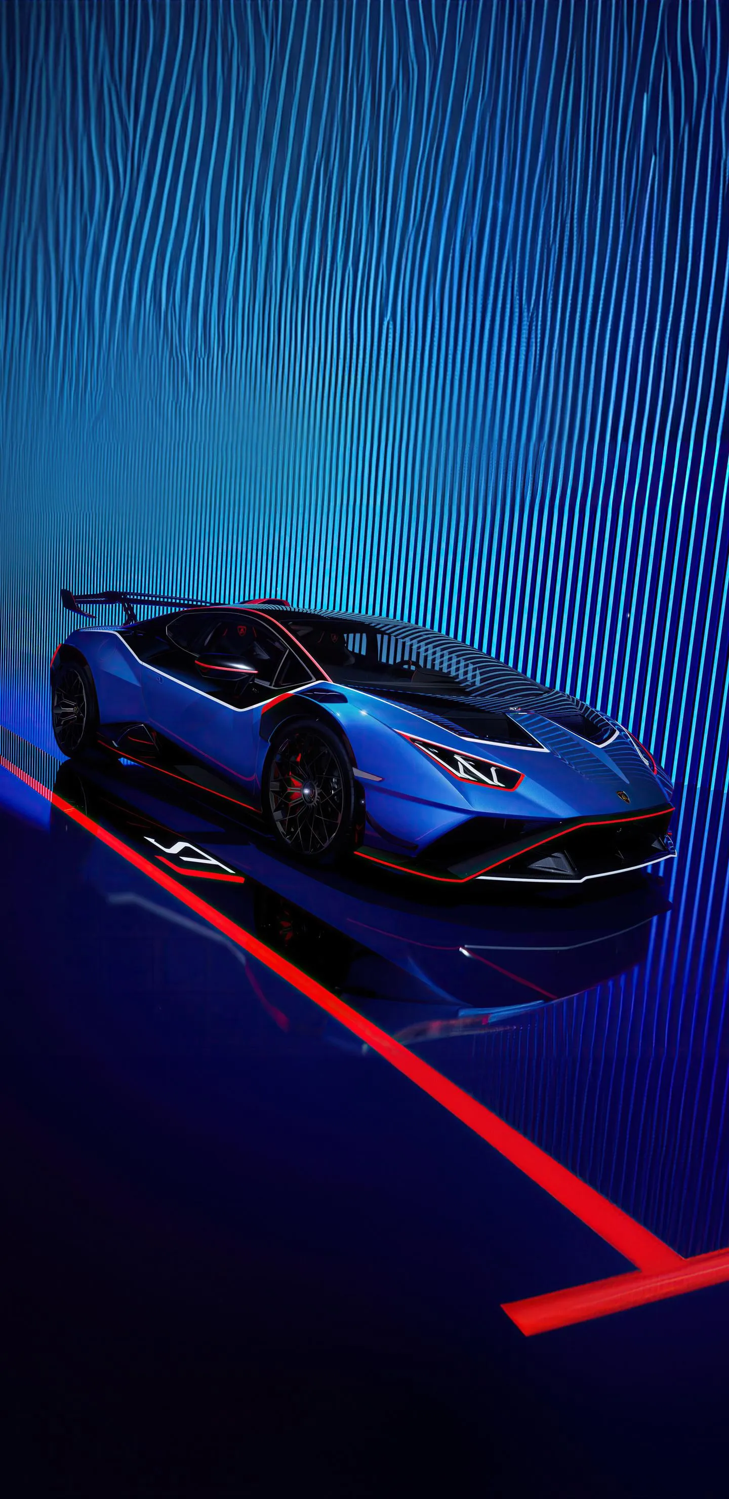 Sleek Blue Sports Car Driving at Night with Neon Light Reflection