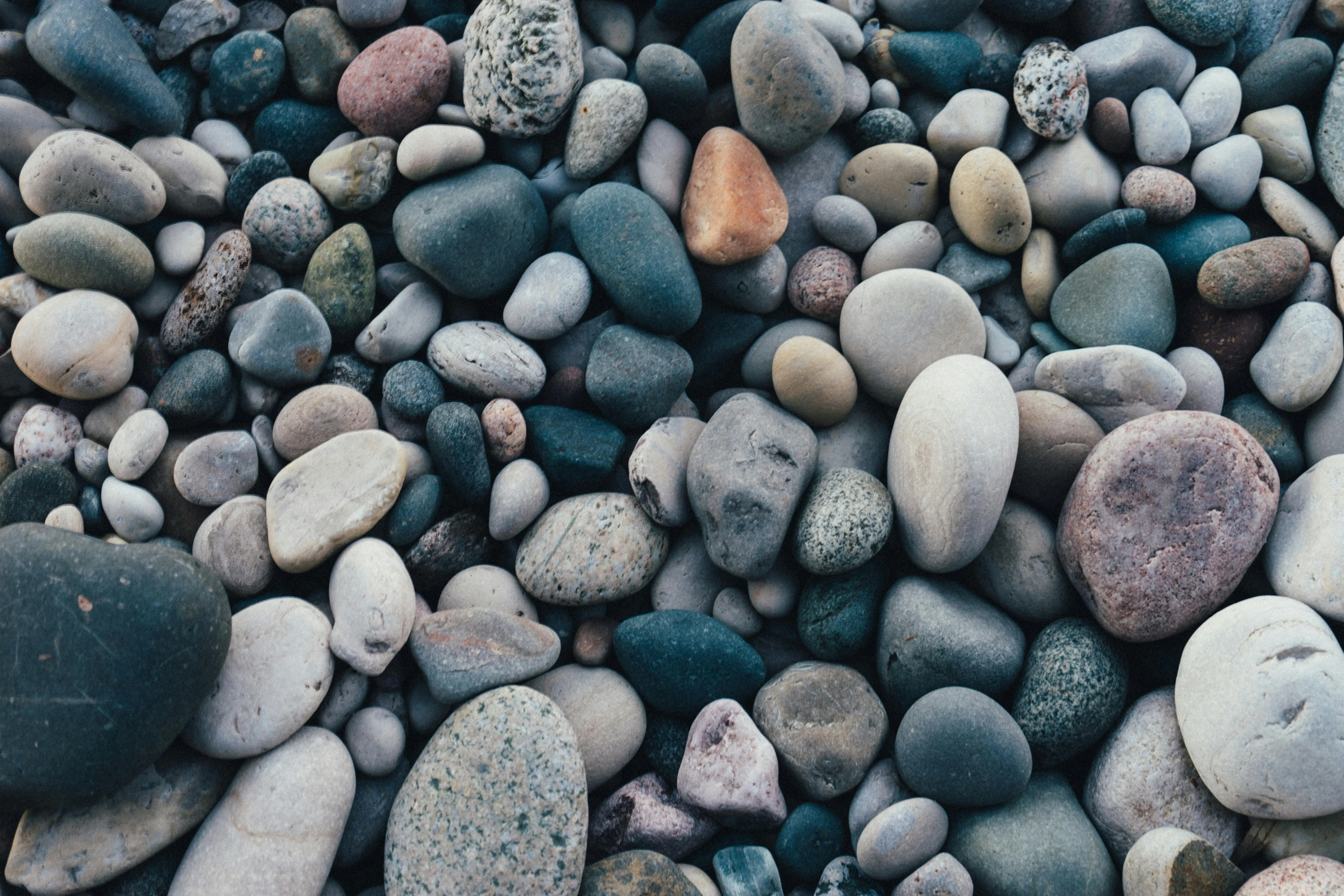 Smooth pebbles in various shades of gray and blue Wallpaper