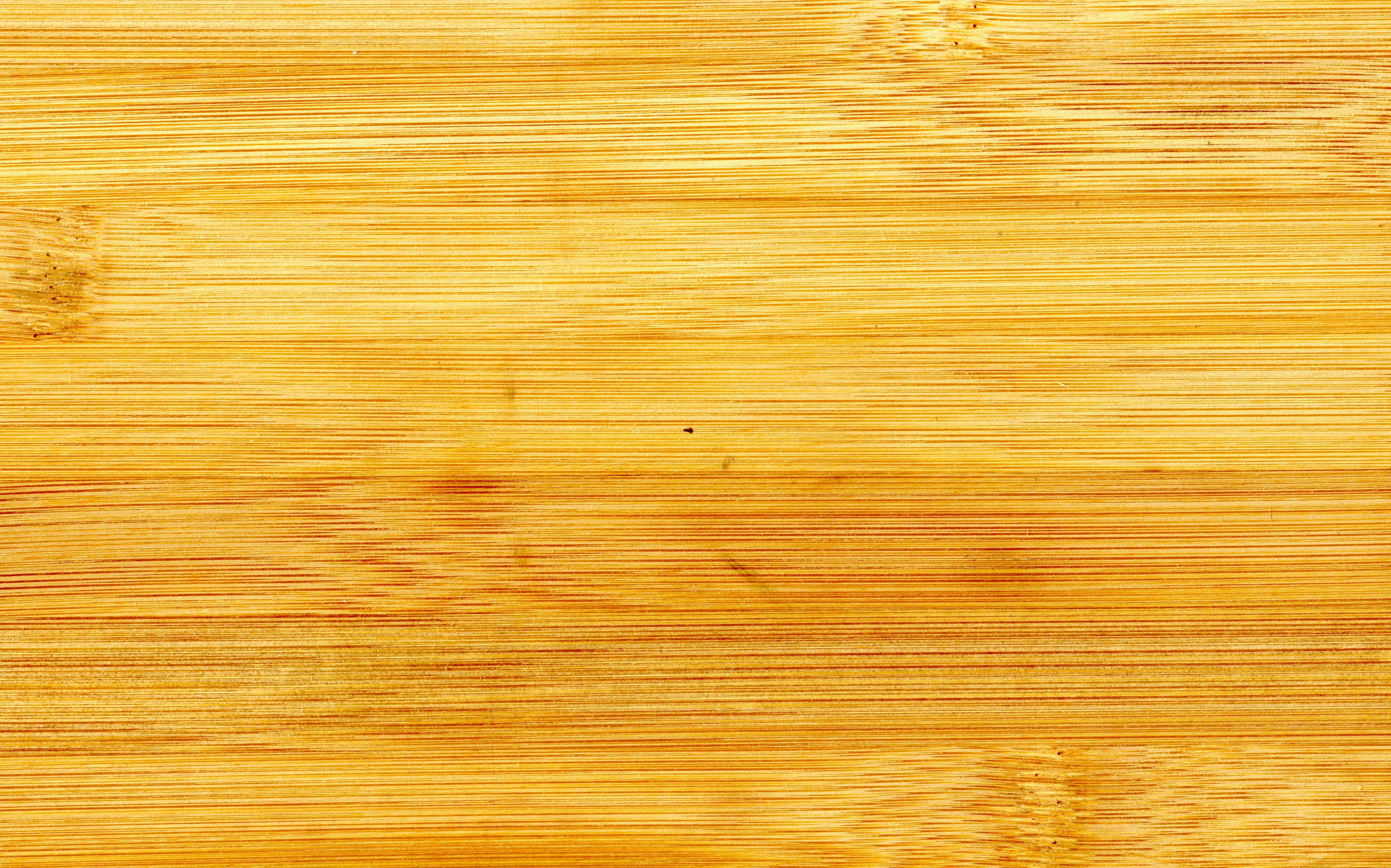 Smooth wooden surface background in a light orange tone