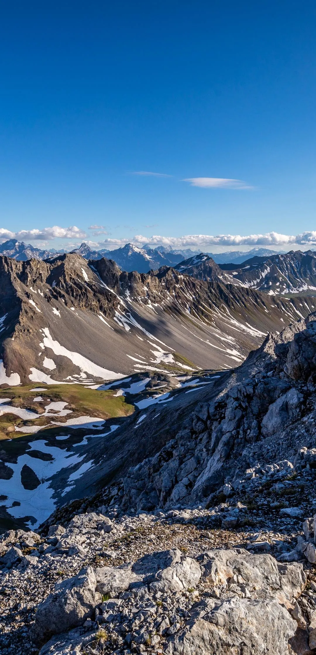 Snowy Mountain Range Under Clear Blue Sky with Bright Sun