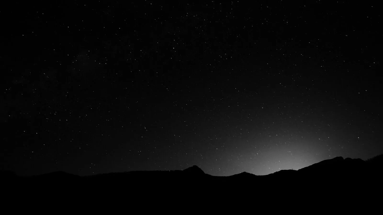 Starry night silhouette with black mountains and space image