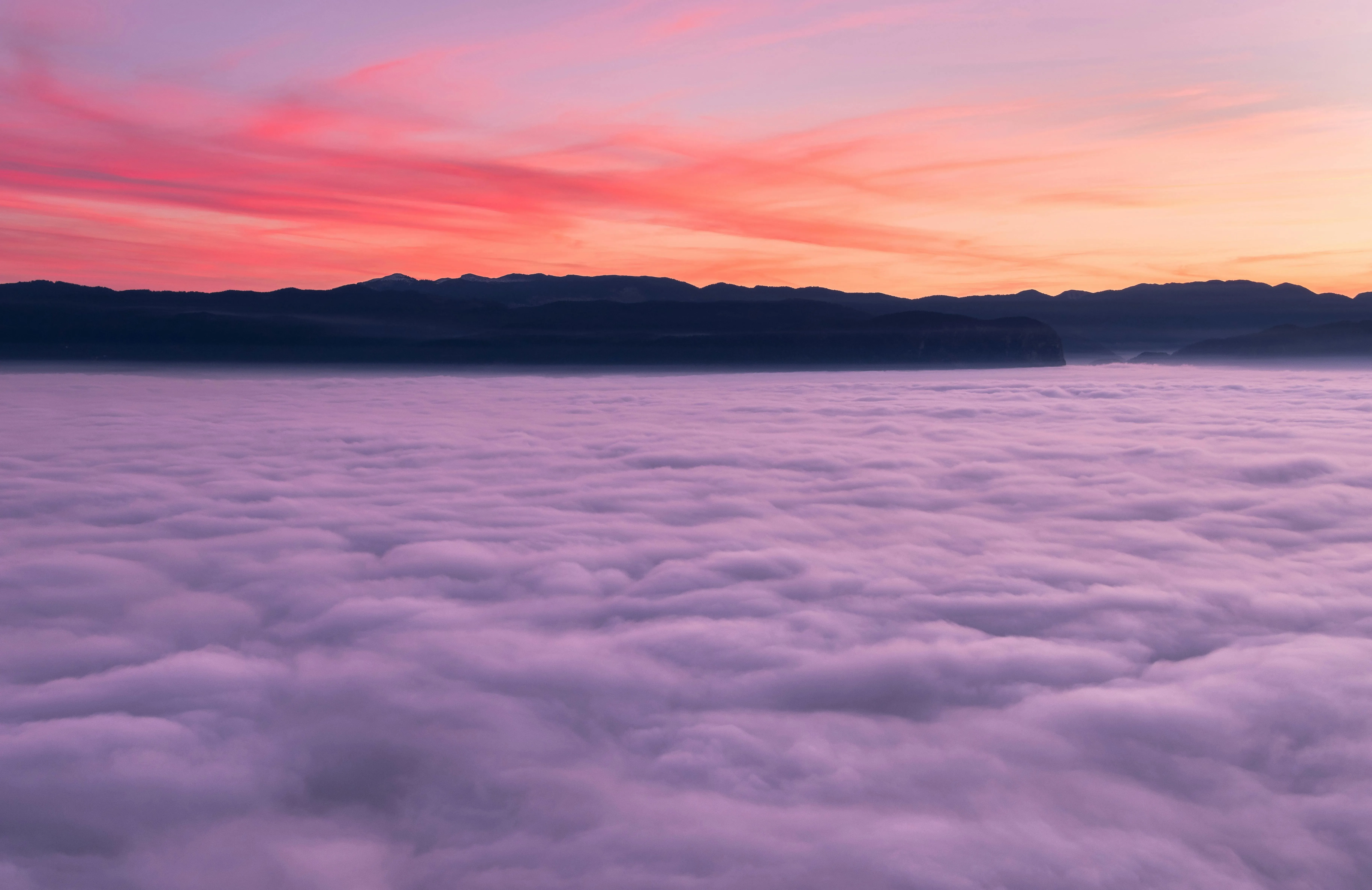 Stunning sunset over a misty purple cloudscape Wallpaper
