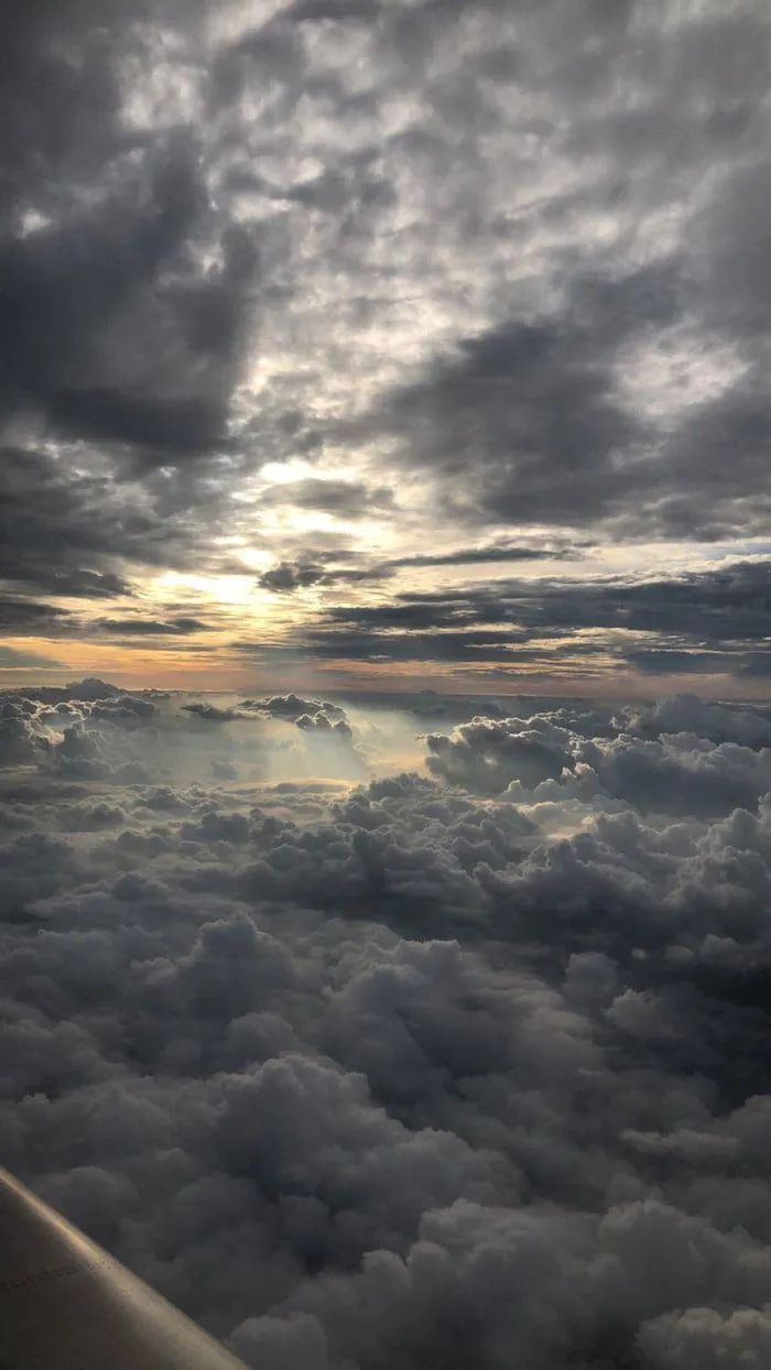 Sunset sky view above clouds from an airplane free Wallpaper