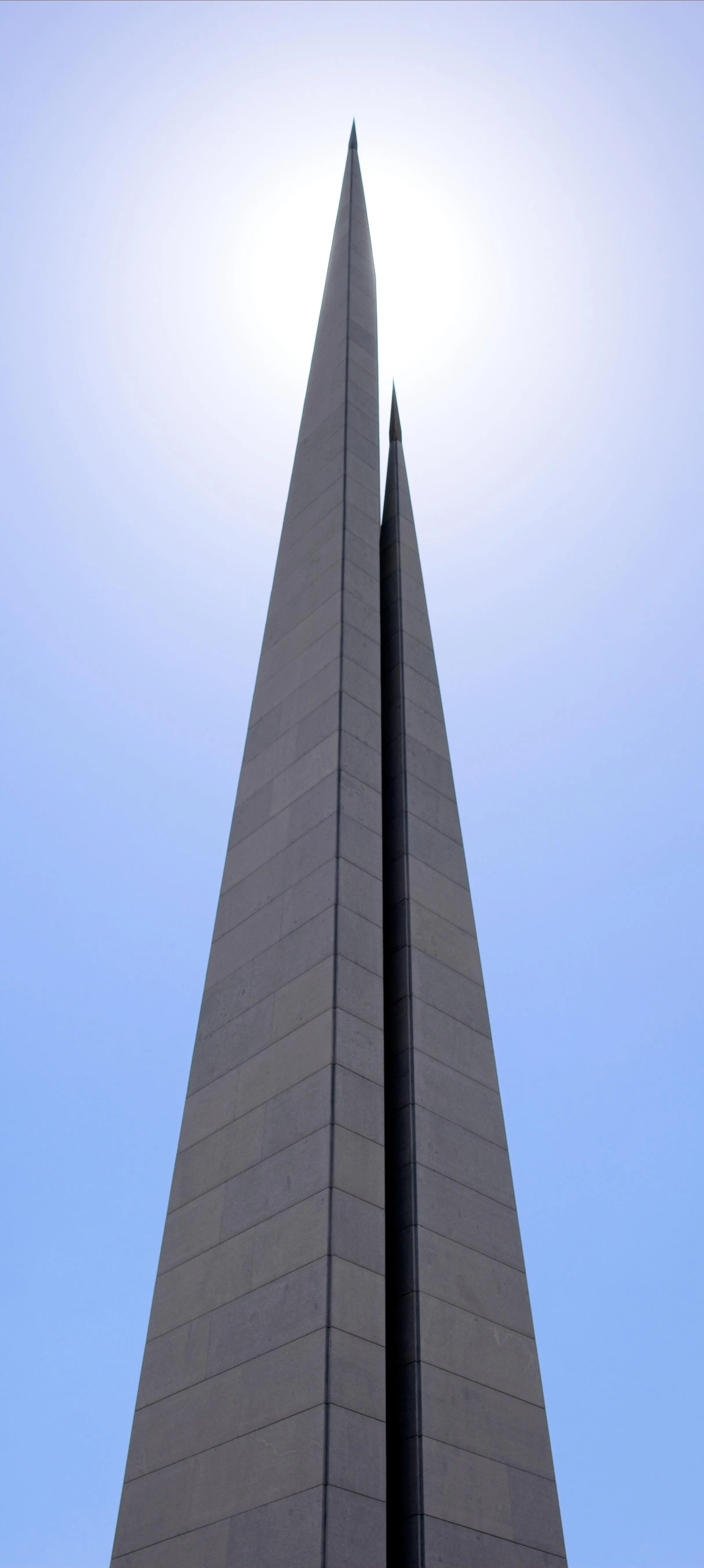 Tall Modern Skyscraper Reaching into Clear Blue Sky