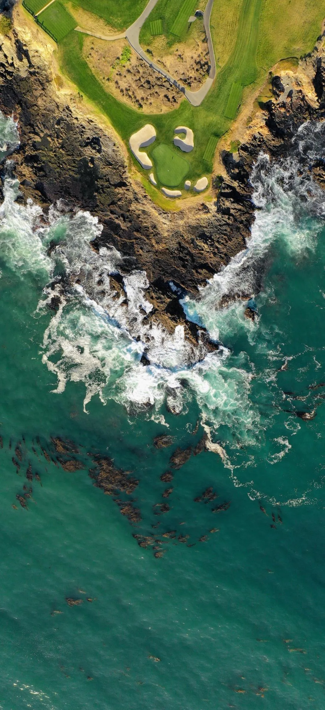 Top Down View of Coastal Cliffs with Turquoise Water Below