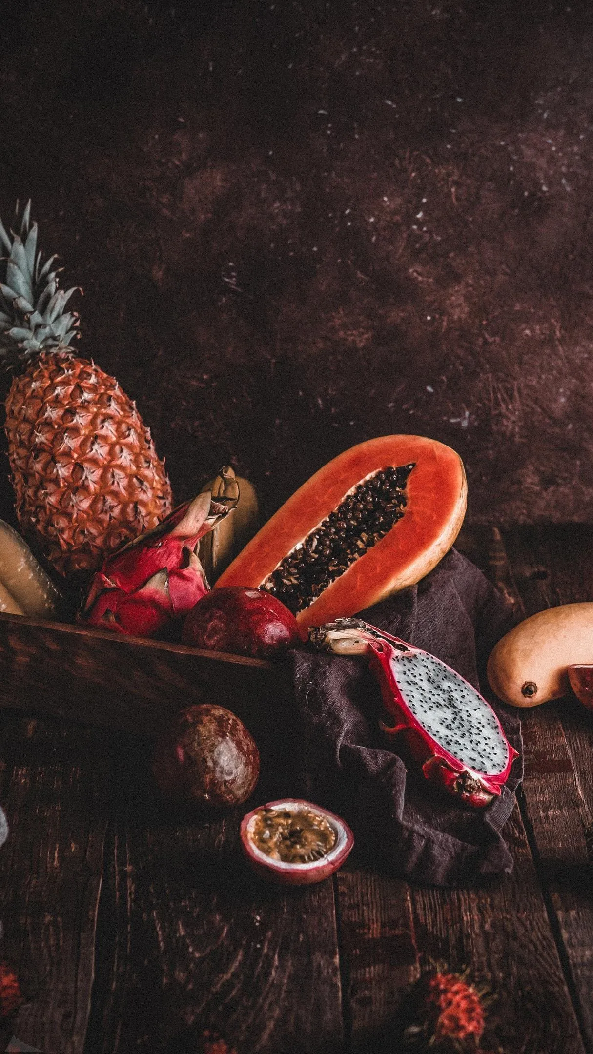 Tropical Fruits Including Pineapple and Papaya on Table Mobile