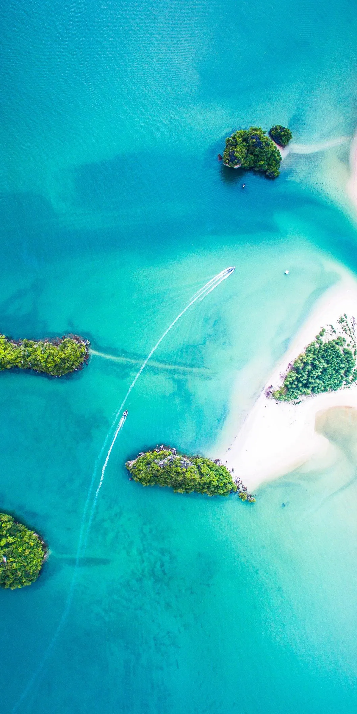 Tropical Island Surrounded by Clear Blue Water from Above