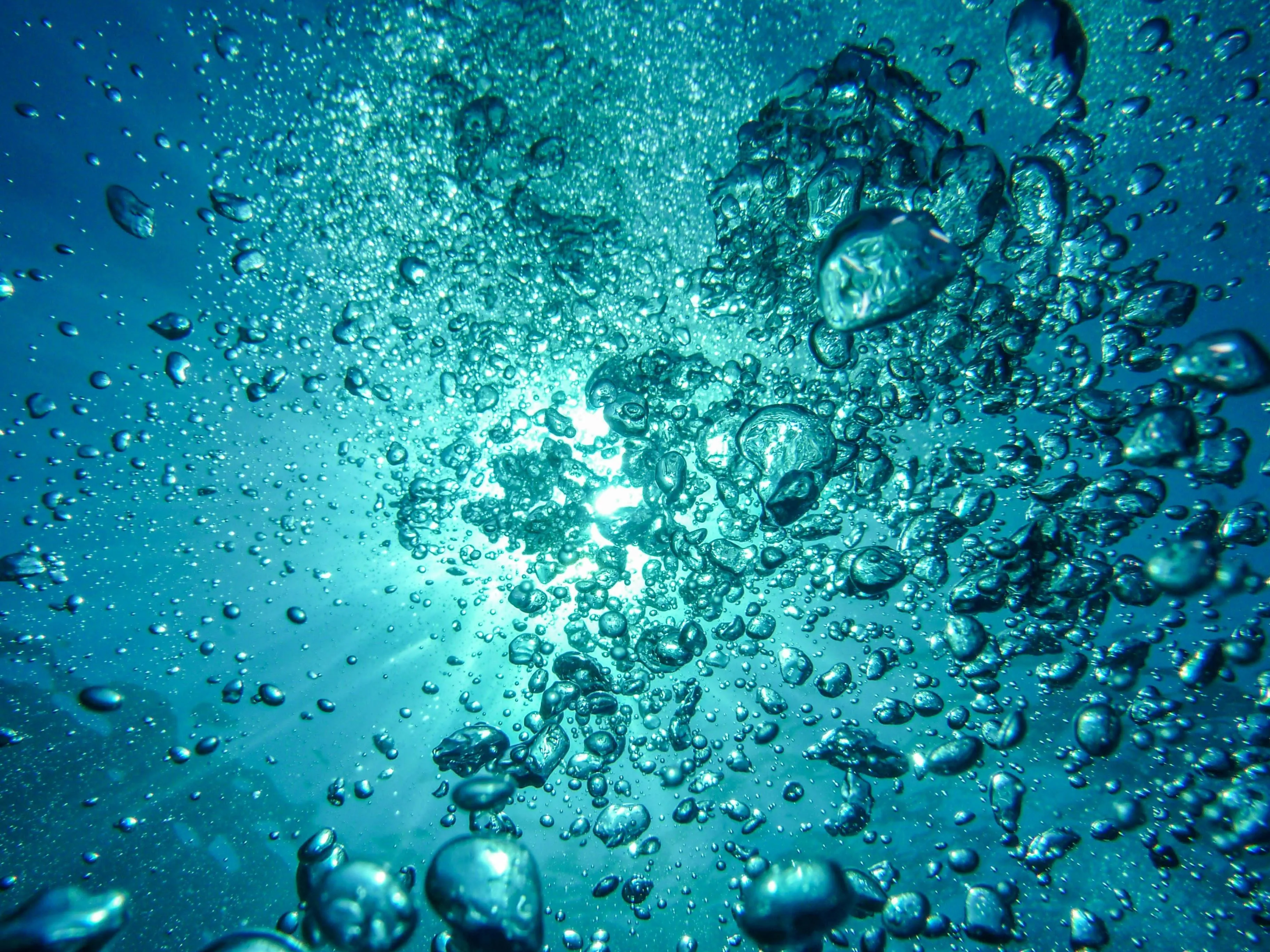 Underwater blue bubbles with sunlight shining through HD