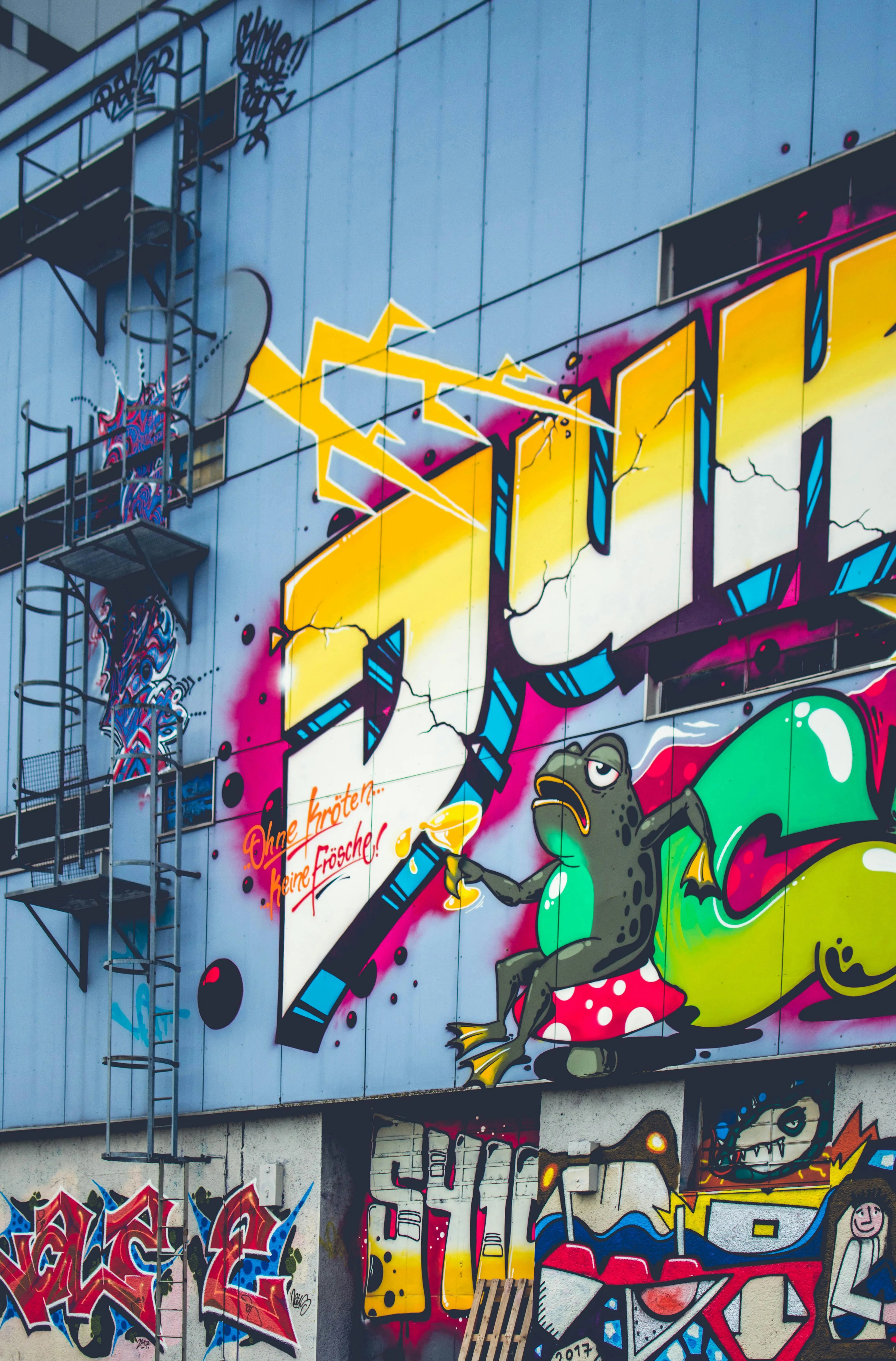 Urban building walls with vibrant colours and art Wallpaper