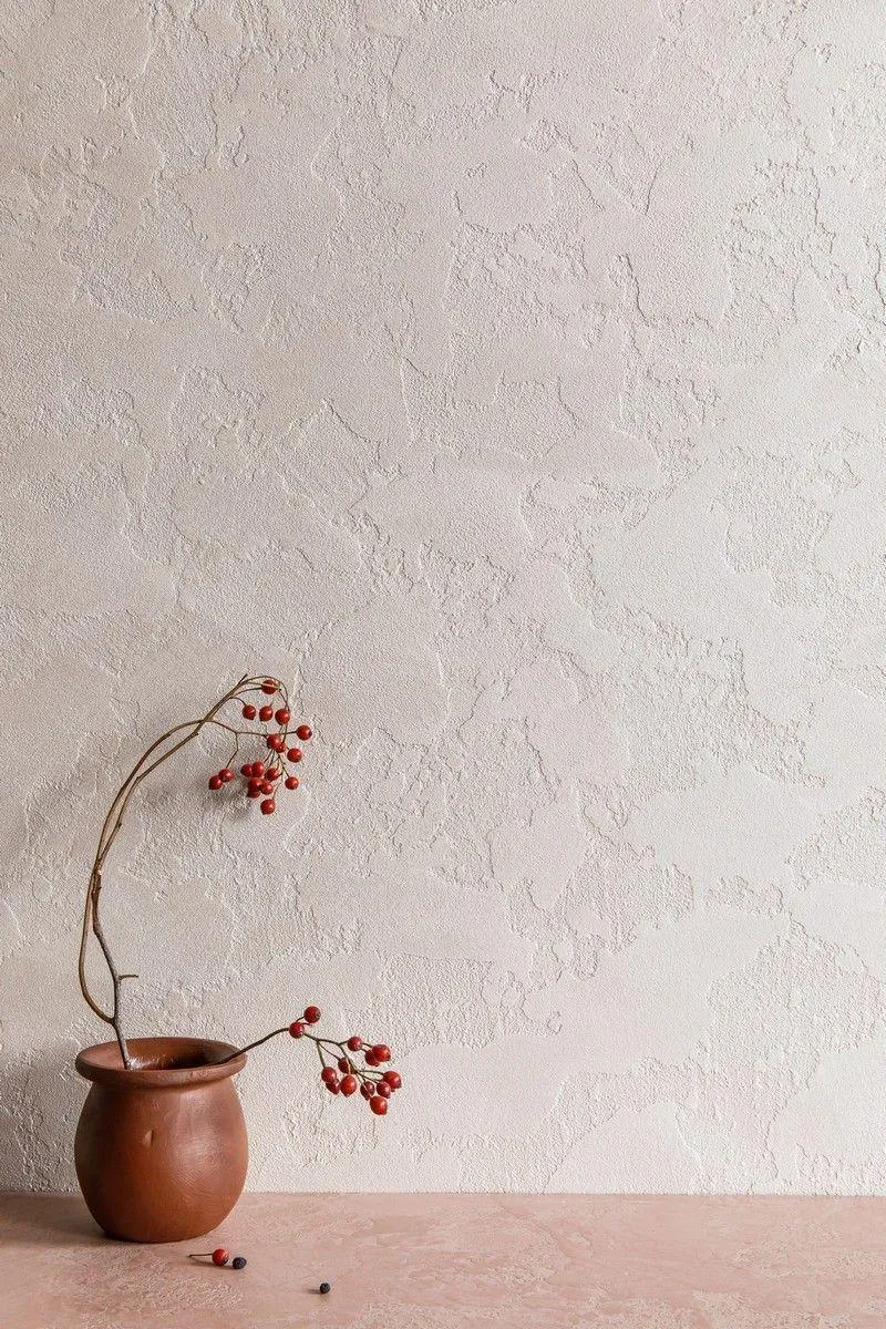Vase with dried flowers on a beige wall free 4K Wallpaper