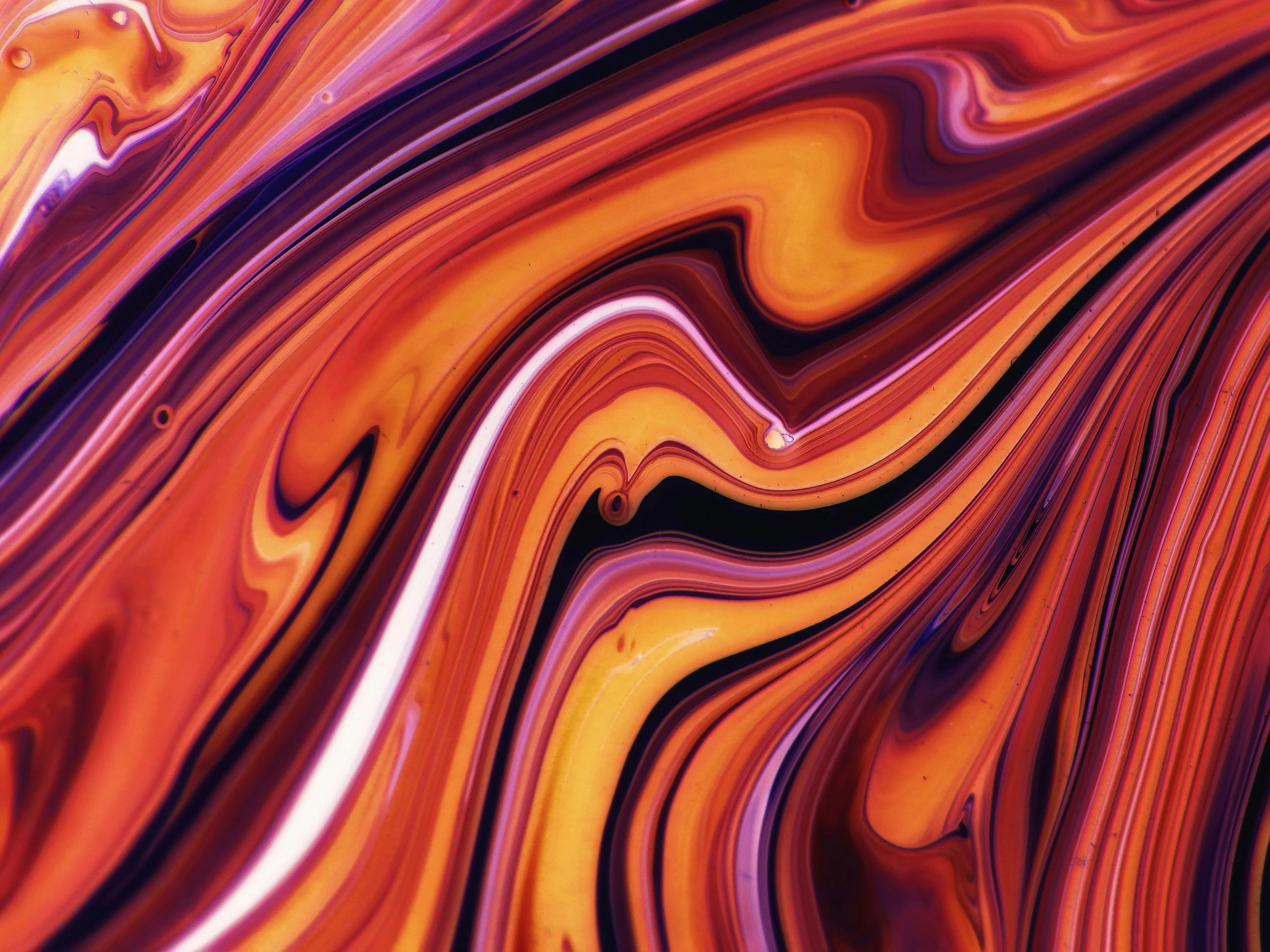 Vibrant orange and red marbled liquid swirl background image