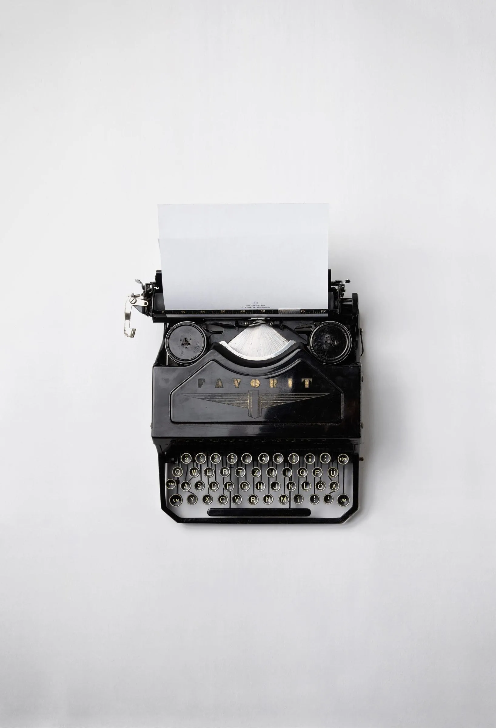 Vintage Typewriter Placed on Clean Minimal White Desk