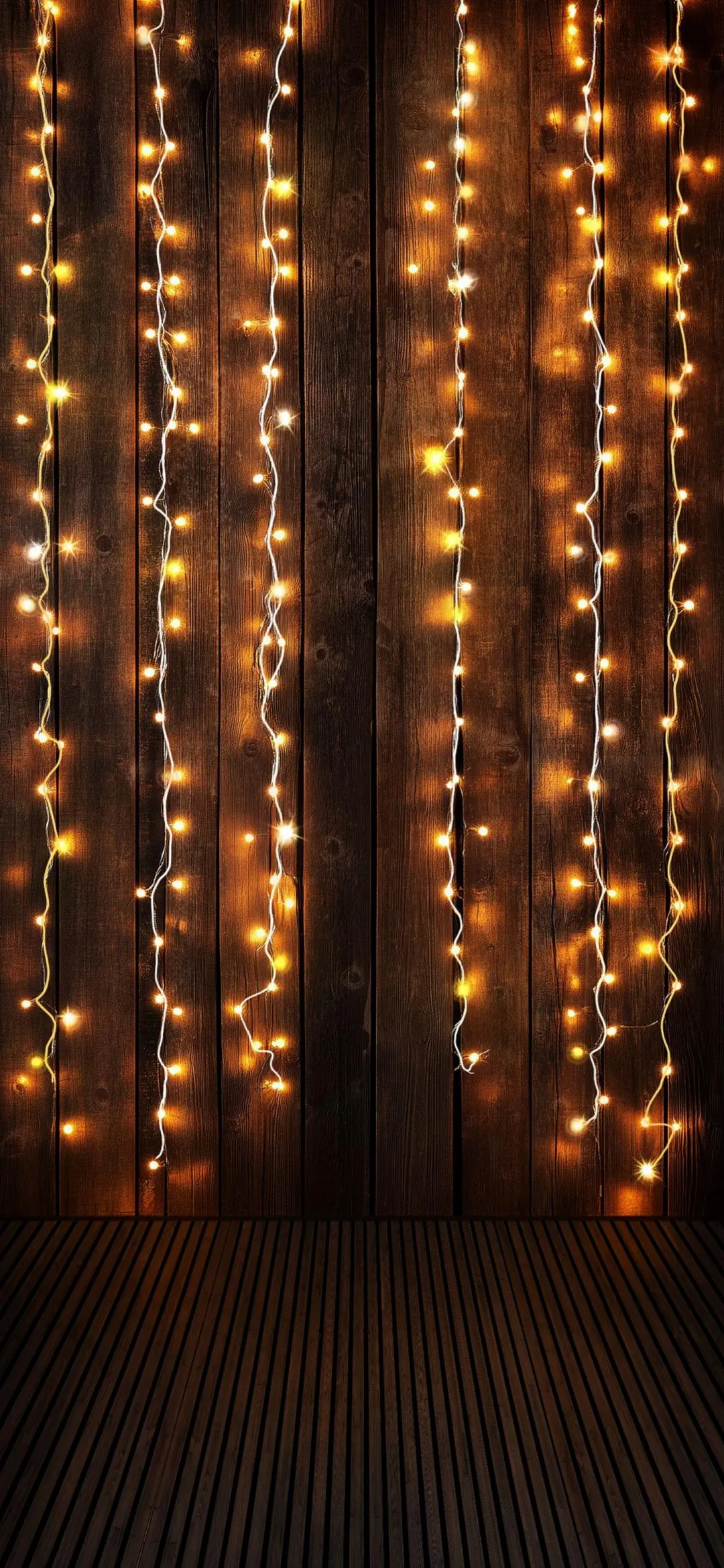 Warm Festive String Lights on Rustic Wooden Wall Background