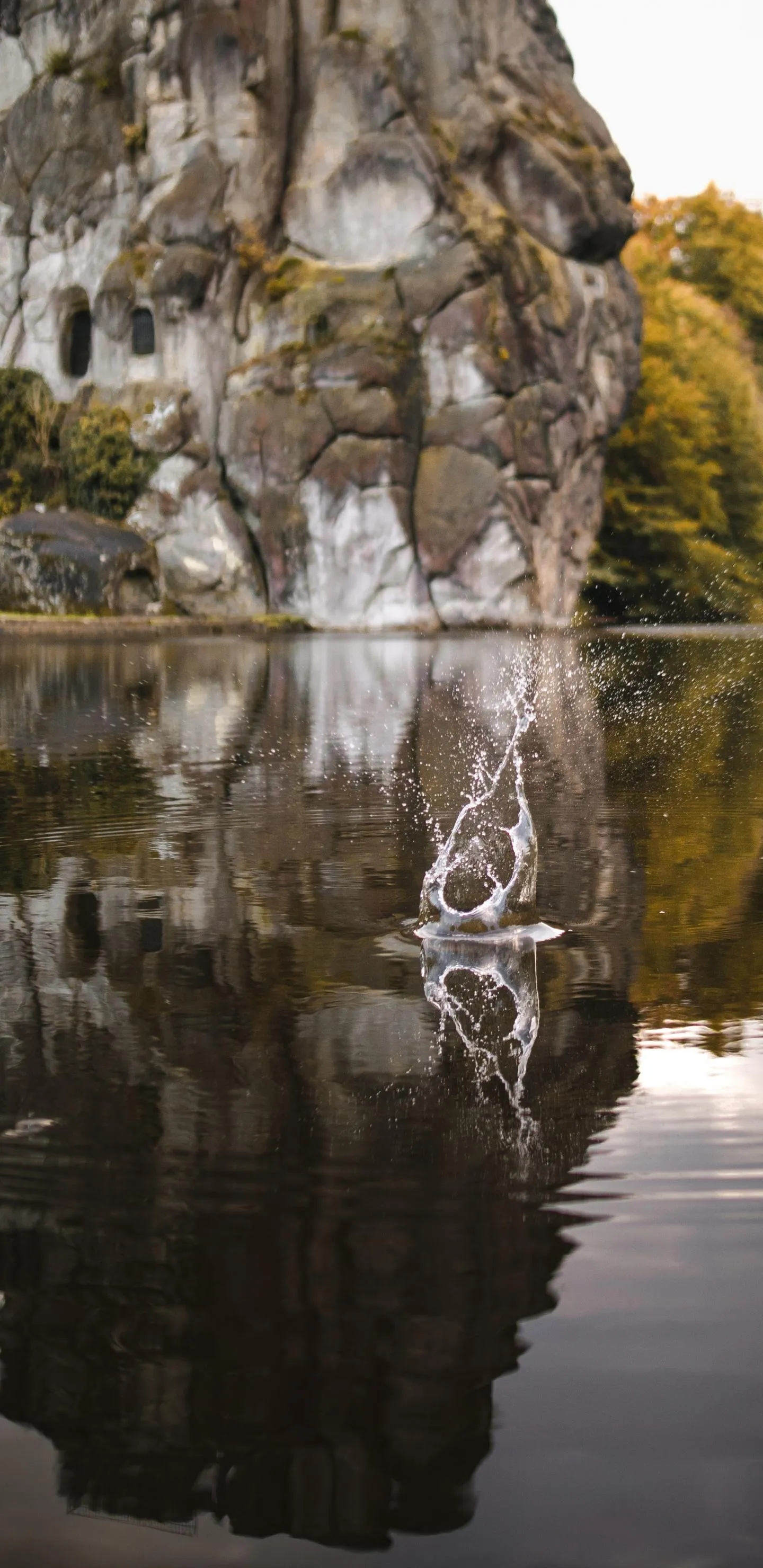 Waterfall Flowing into Calm River Surrounded by Trees