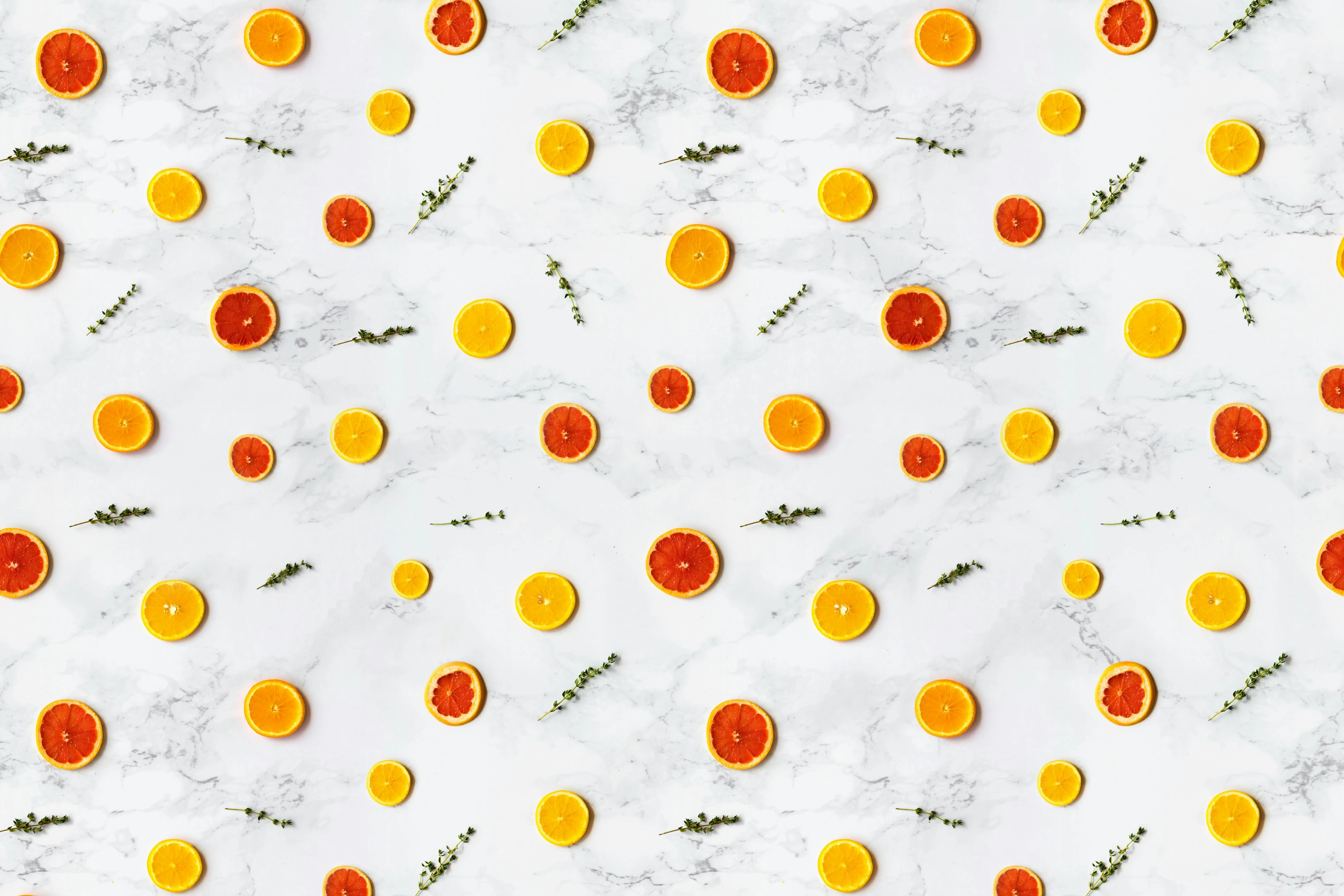 White marble texture with scattered citrus fruit slices