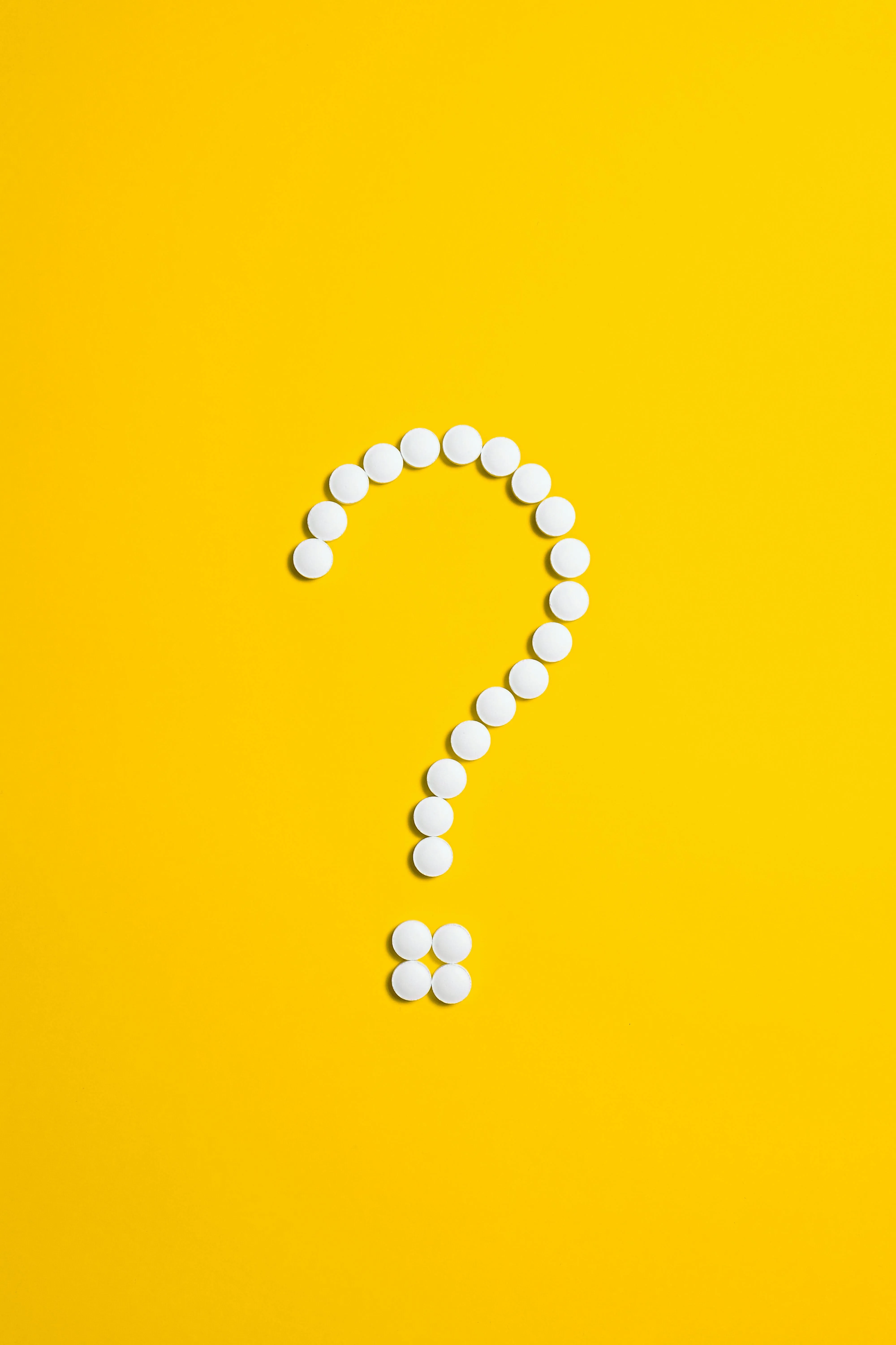 Yellow background with a question mark made of white pearls