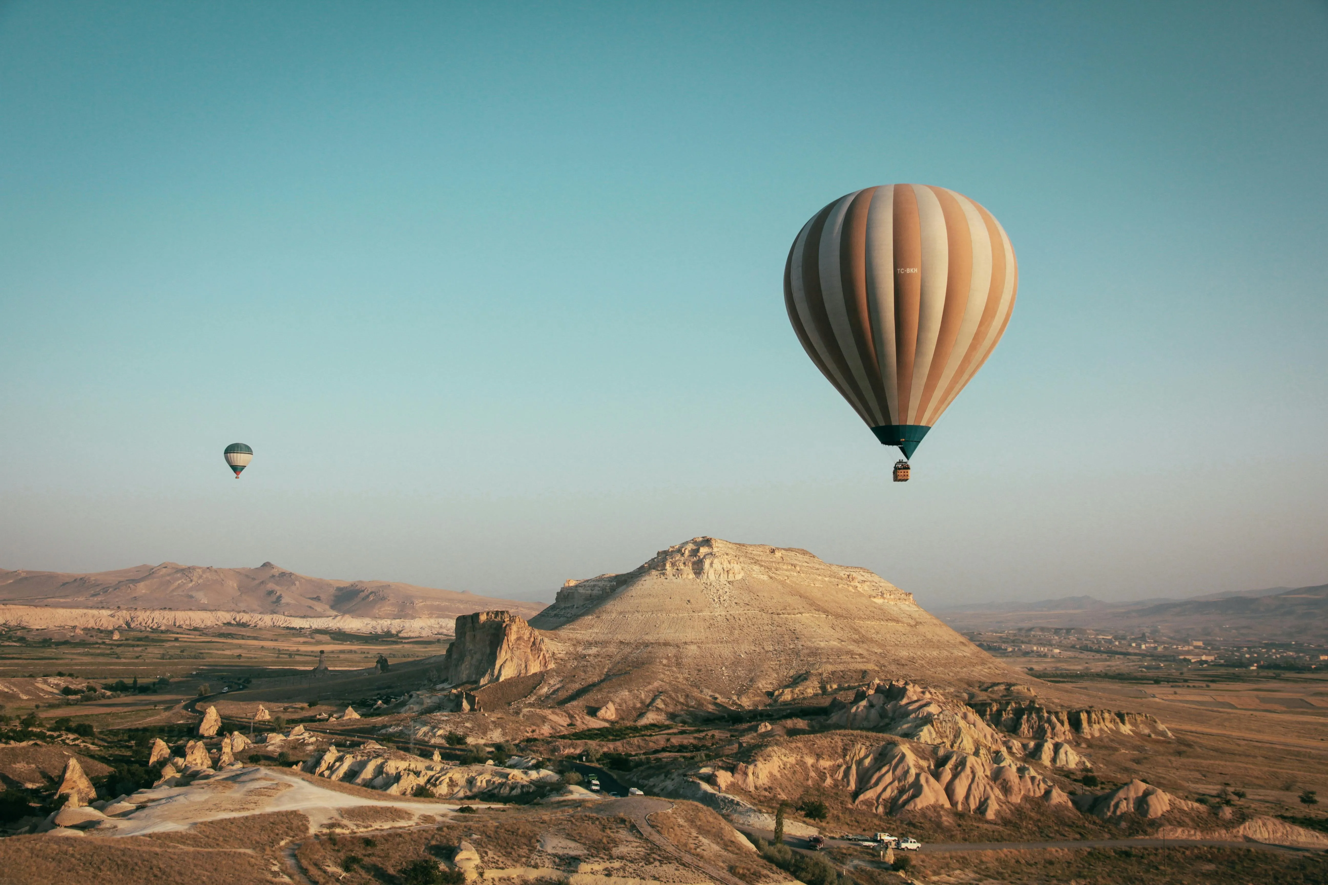 Hot Air Balloon Floating Over Beautiful Rocky Mountain Scene