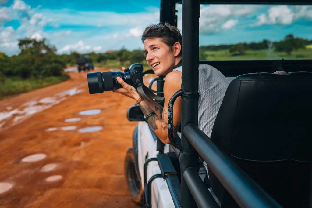 Photographer Capturing Wildlife Moments in Safari Jeep
