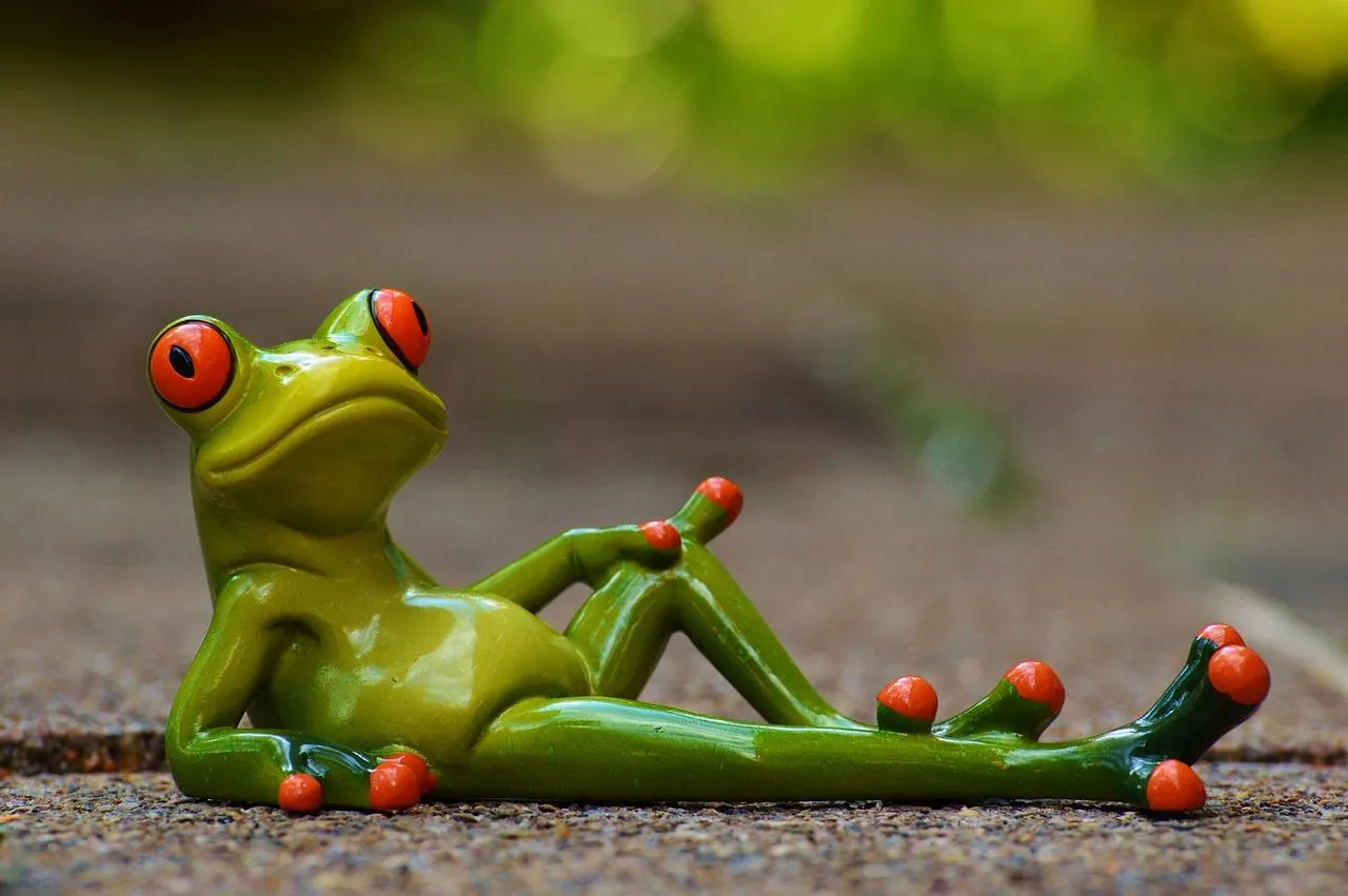 Relaxed Green Tree Frog Resting on a Branch Outdoors