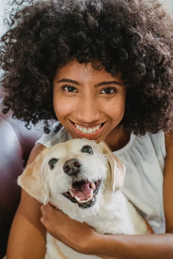 Smiling Woman Hugging Her Happy Dog and Posing Wallpaper