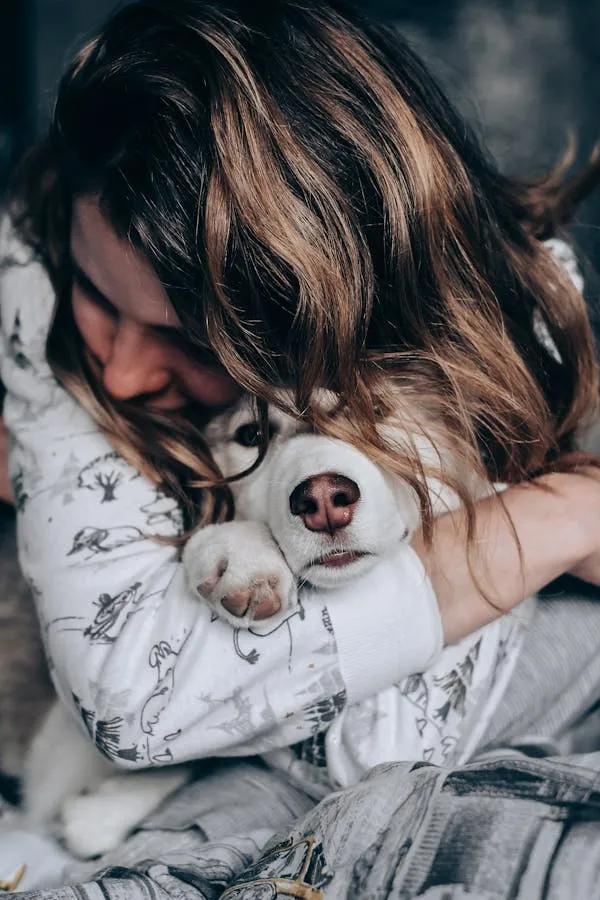 Woman Hugging a Dog Tightly with Affection Free Wallpaper