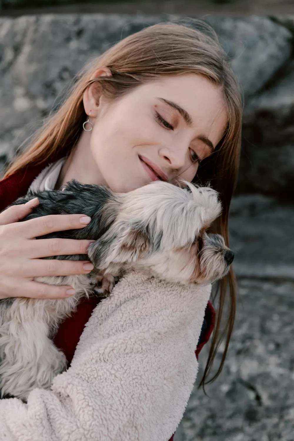 Woman Hugging Her Fluffy Puppy with Love and Warmth Image