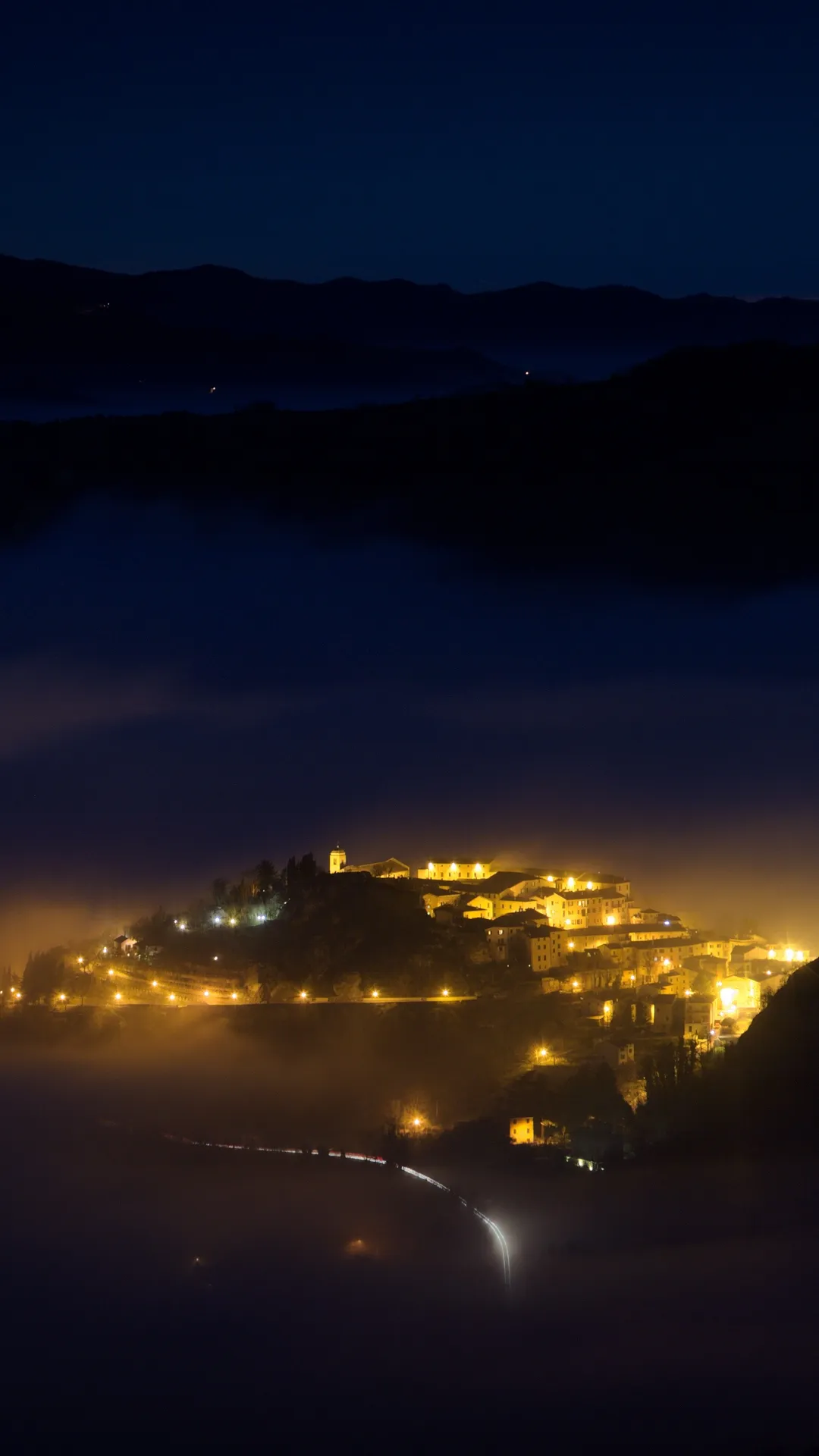 Houses in the mountain shining in the dark night wallpaper