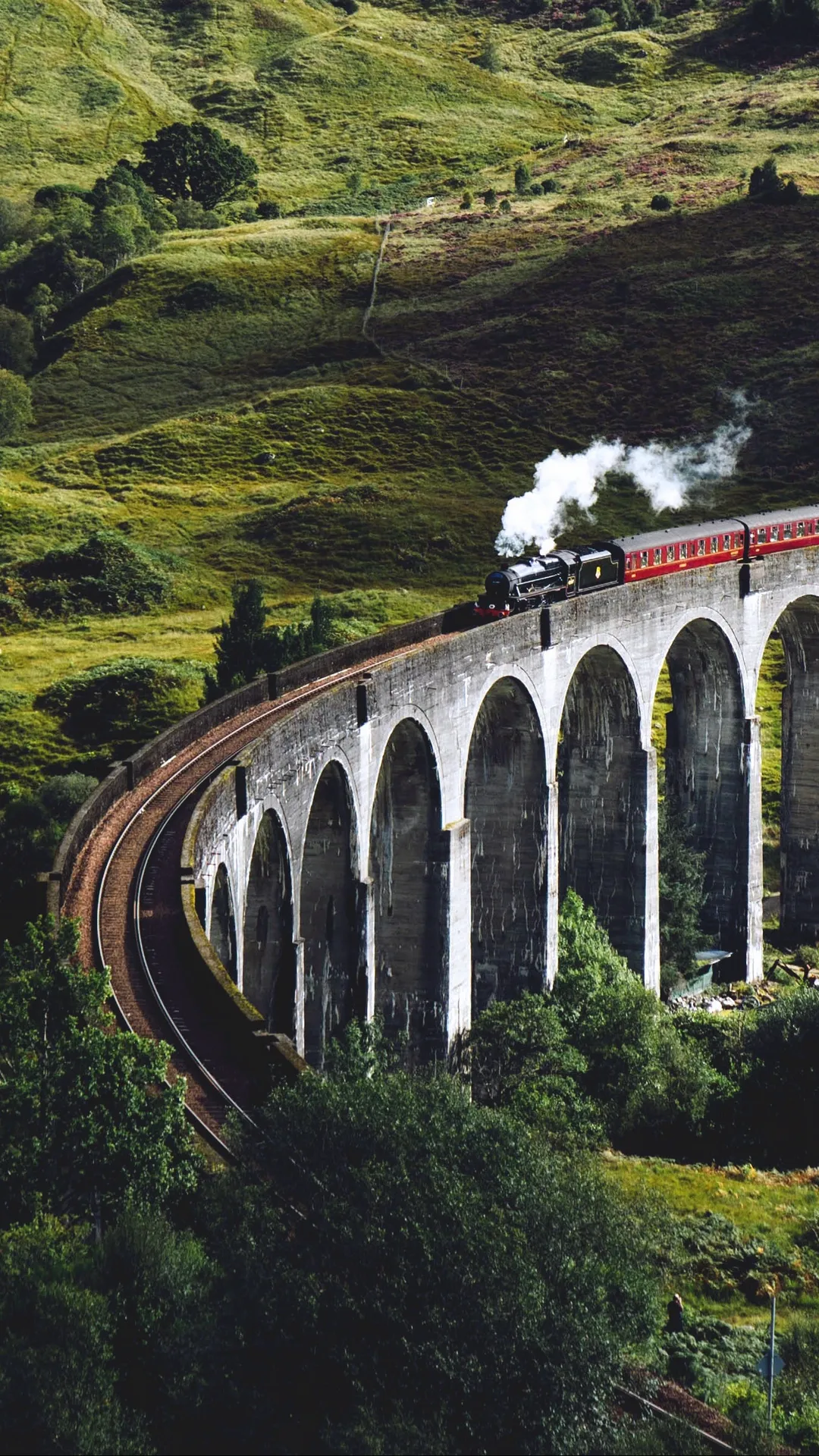 Train moving over the bridge in hills images for wallpapers