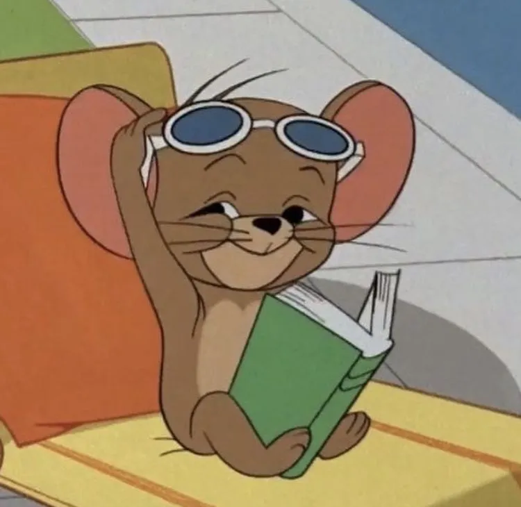 Jerry reading a book with glasses and peaceful expression
