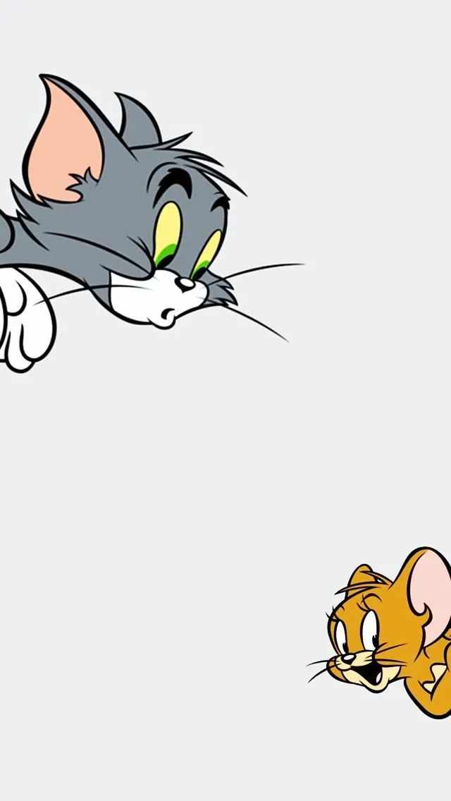Tom and Jerry peeking at each other with smiles wallpaper