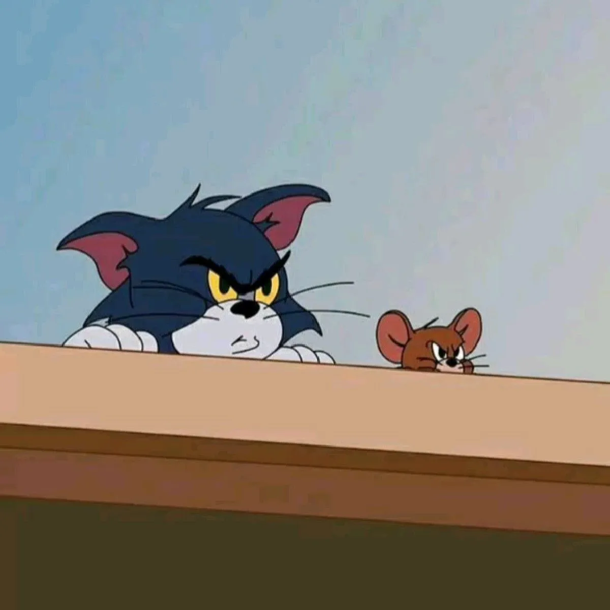 Tom and Jerry Peeking from Table Edge in a Cartoon Scene
