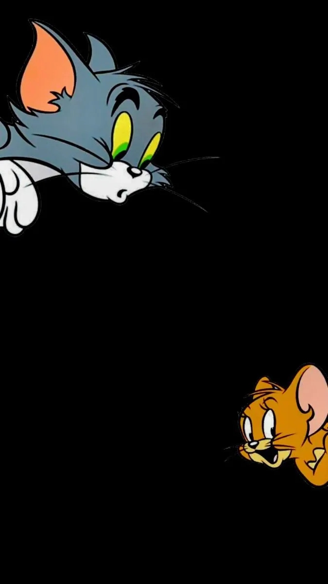 Tom hiding behind a black background looking wallpaper