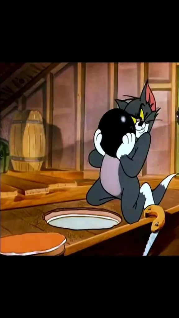 Tom Holding a Black Bomb Near a Trap in the Attic Scene