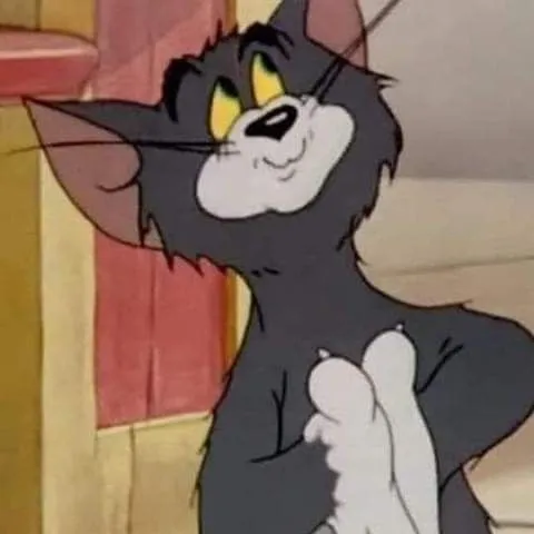 Tom looking confident with hands on hips in a room