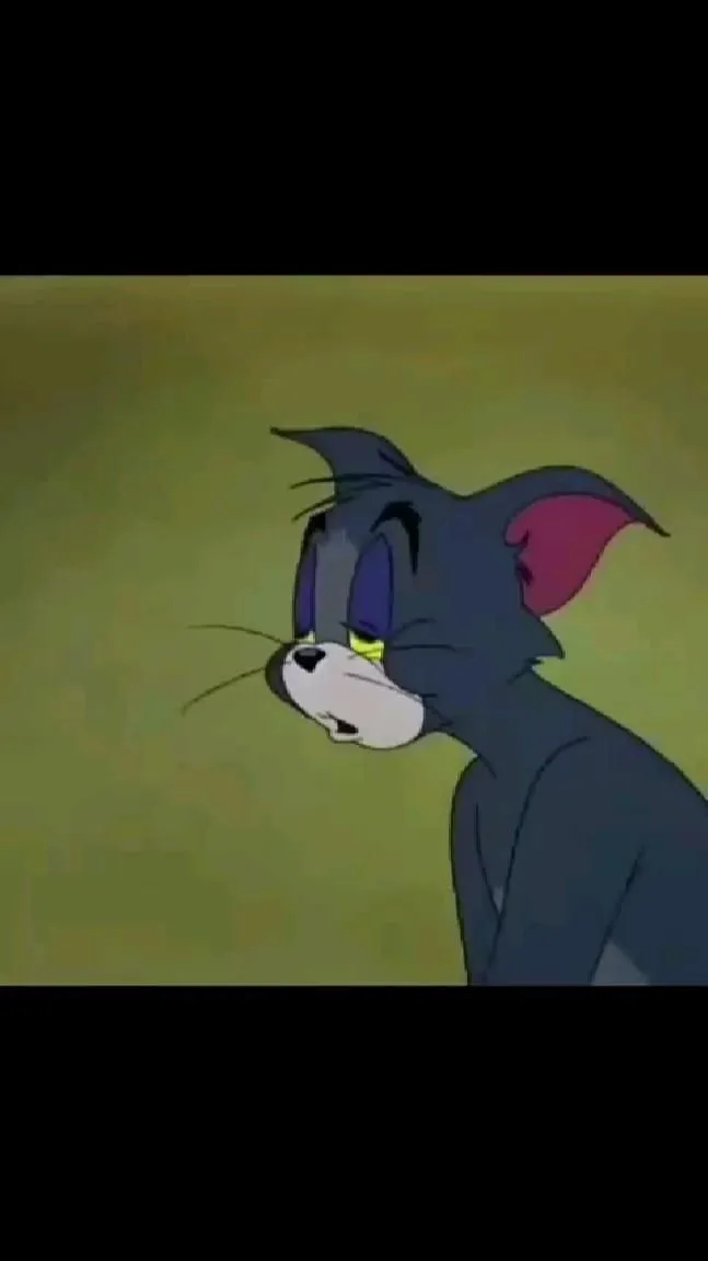 Tom looking serious on a dark green background wallpaper