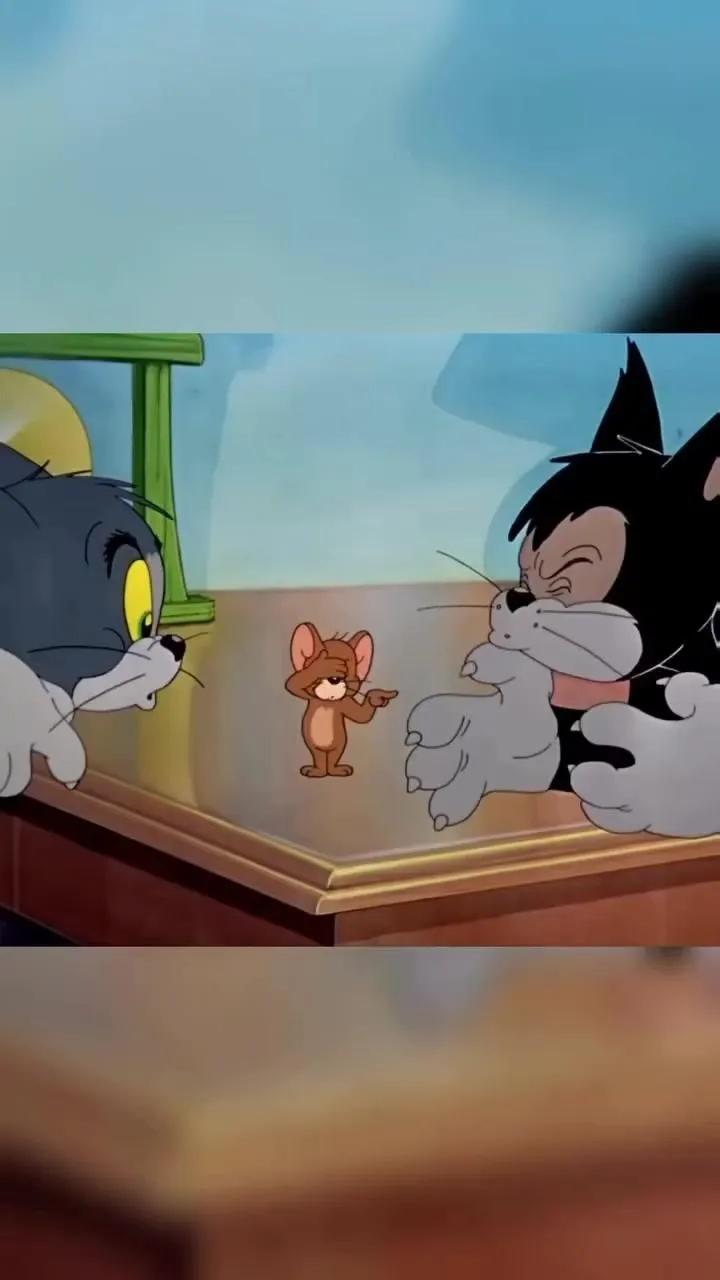 Tom peeking from door while Jerry jumps in surprise