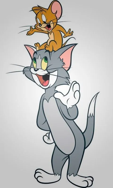 Tom standing and smiling on a grey gradient wallpaper