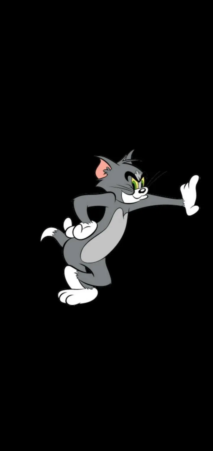 Tom standing with arms spread on a black background