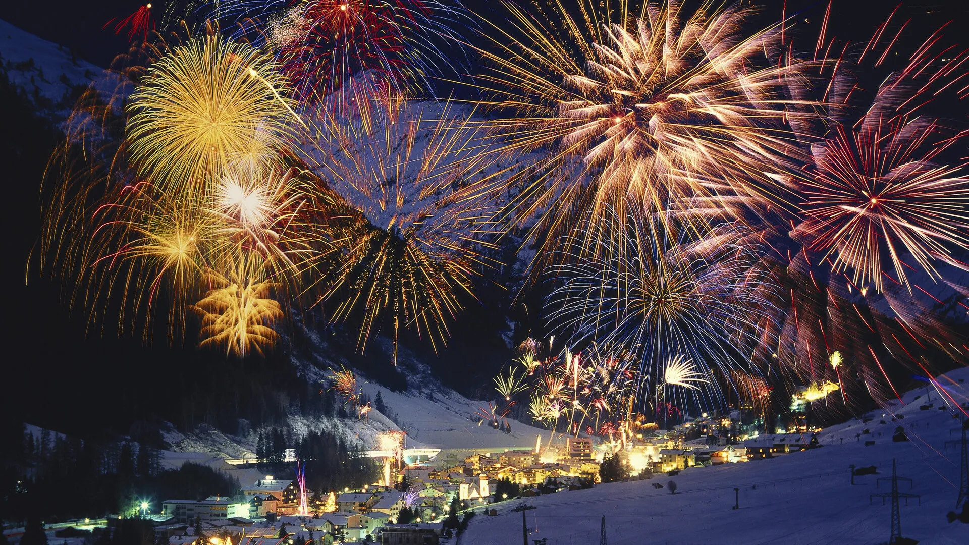 Blue and Golden Fireworks Against the Night Sky Wallpaper