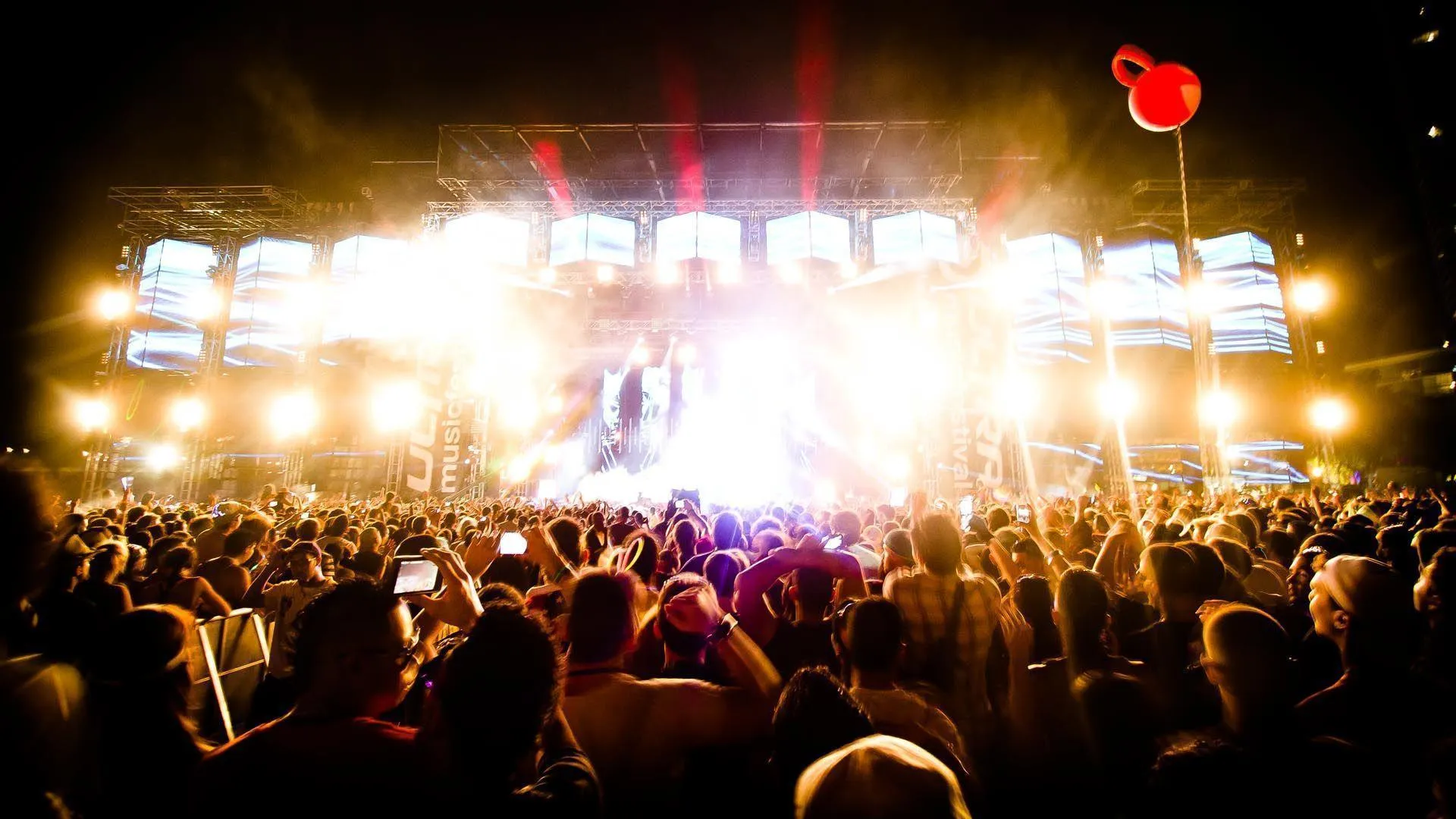 Bright Lights and Energy at Night Music Festival Crowd