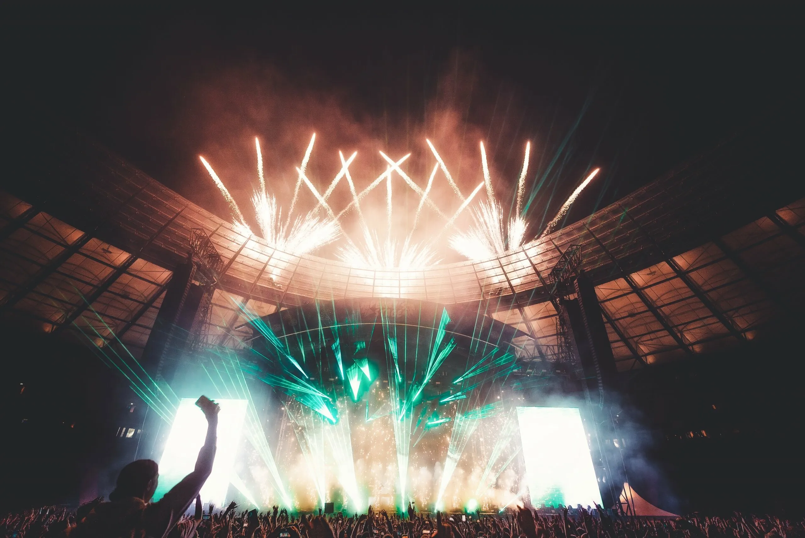 Crowd in Concert with Fireworks Show and Colourful Lights