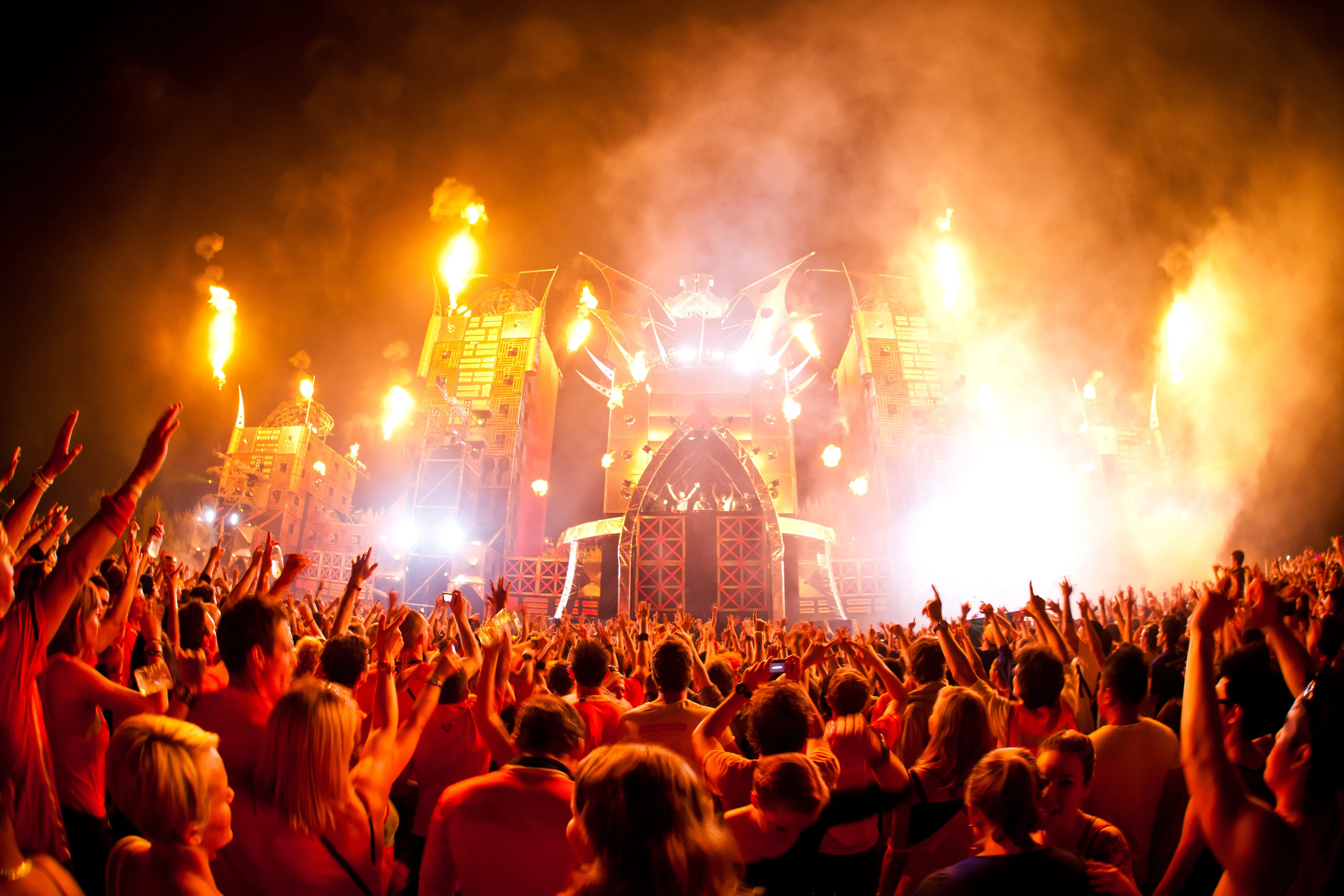 Music Festival Crowd with Fire and Stage Lights Wallpaper