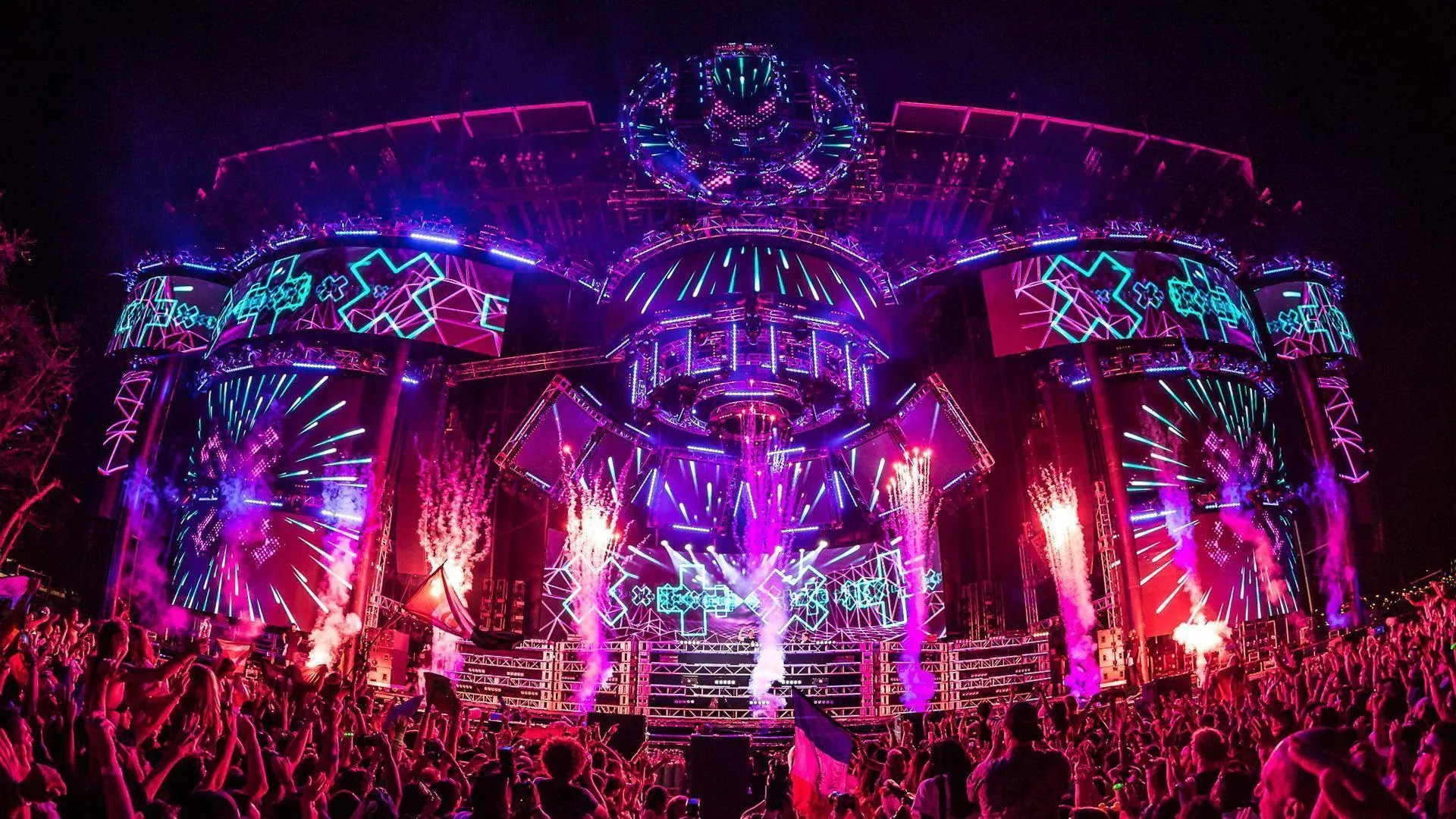 Neon Lights and Fireworks Stage Concert with a Wide Crowd